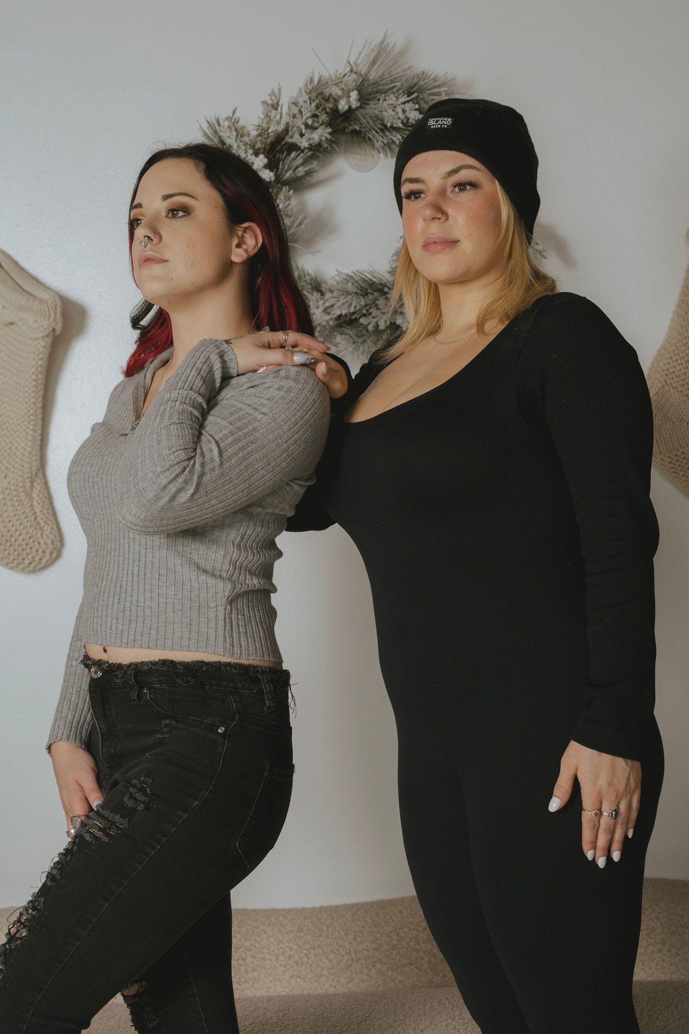Two people in casual attire posing together in a series of artistic indoor photos.