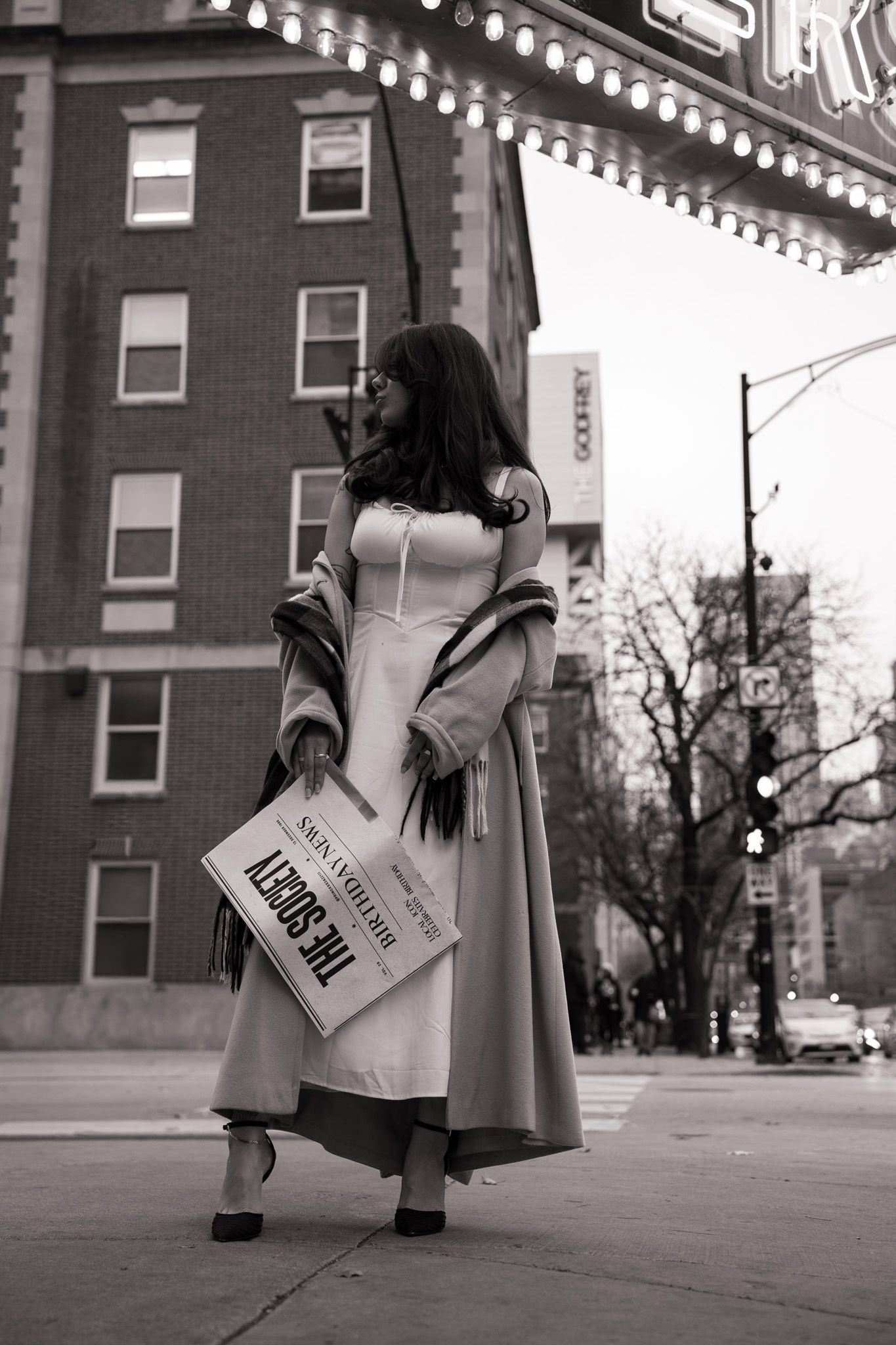 A black and white photo sequence shows a person in a long coat holding a shopping bag on a city sidewalk.