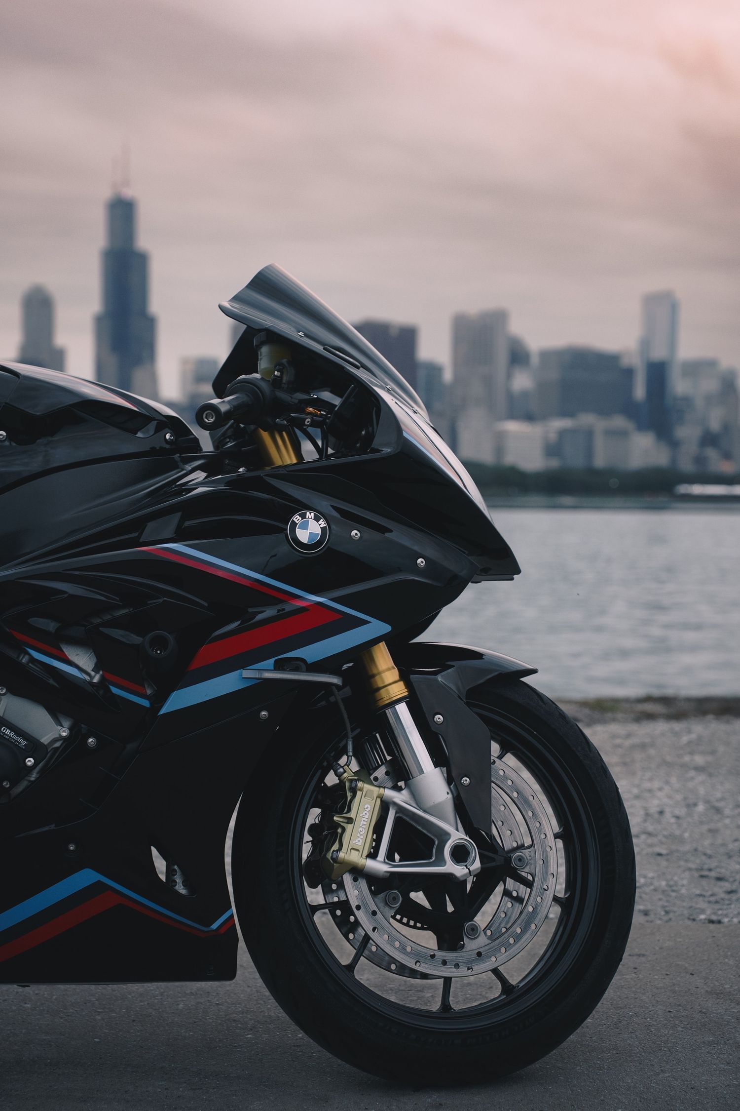 Black BMW sportbike parked along the waterfront with Chicago skyline in background.