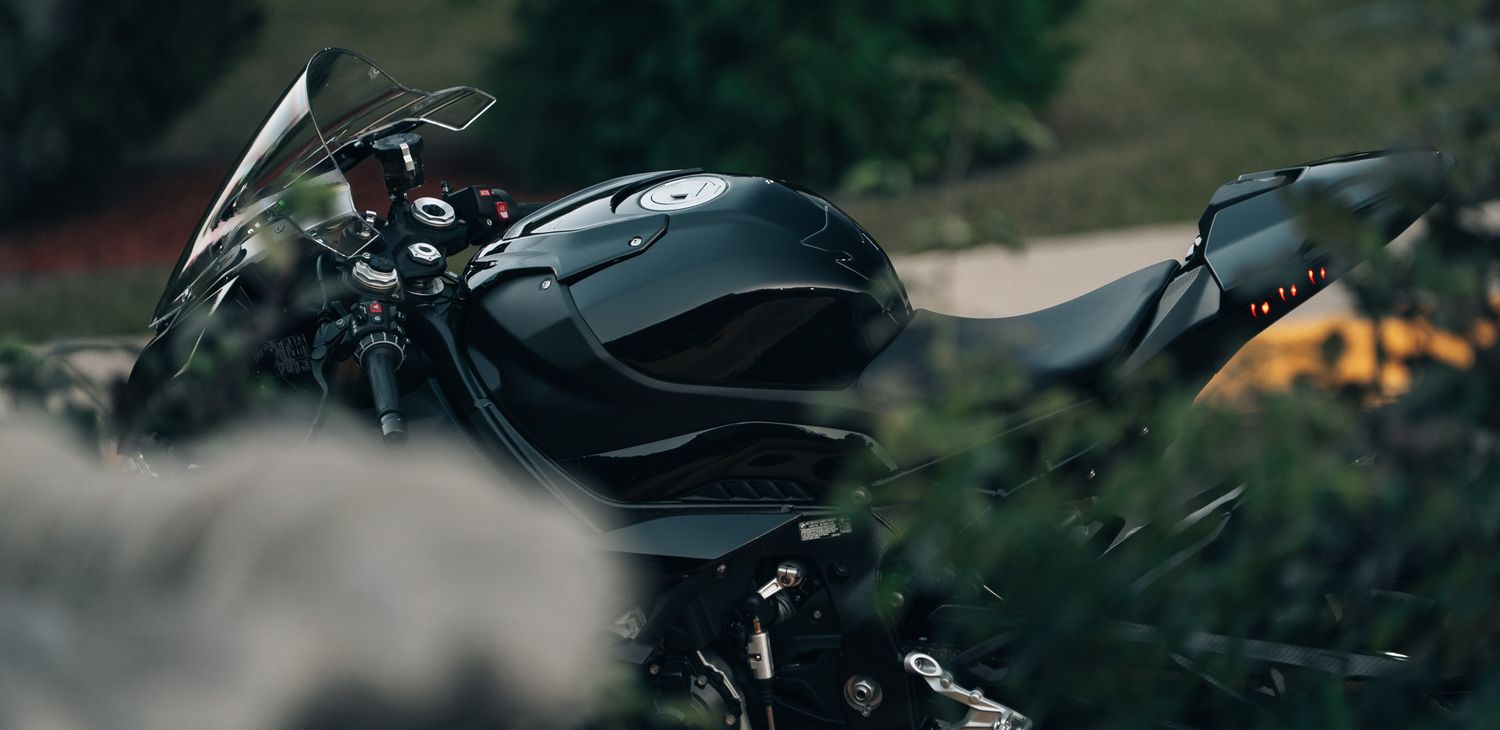 Side profile of a black BMW sport motorcycle in dramatic lighting.
