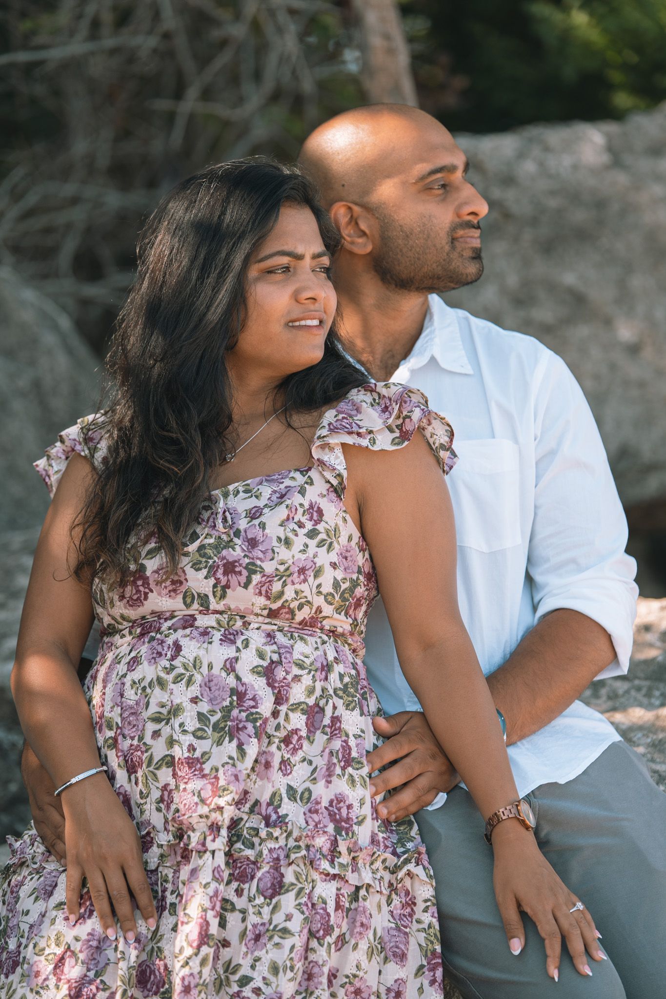 A couple laughs together during their outdoor engagement session.