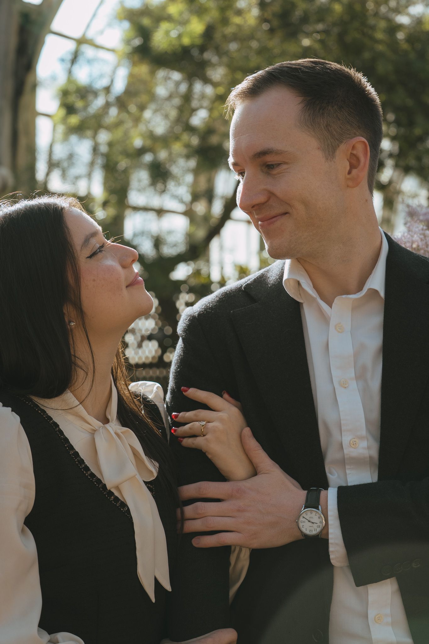 A romantic sequence showing tender interactions between a couple in formal attire outdoors.