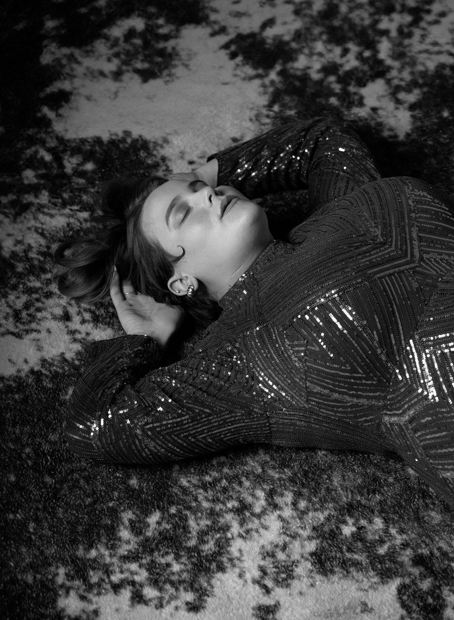 Dramatic black and white photo series of a person in sparkly attire.