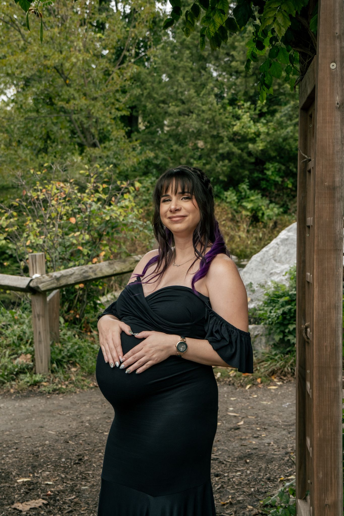 A series of five outdoor portraits showing someone in a black dress posing against a natural backdrop with trees and foliage.