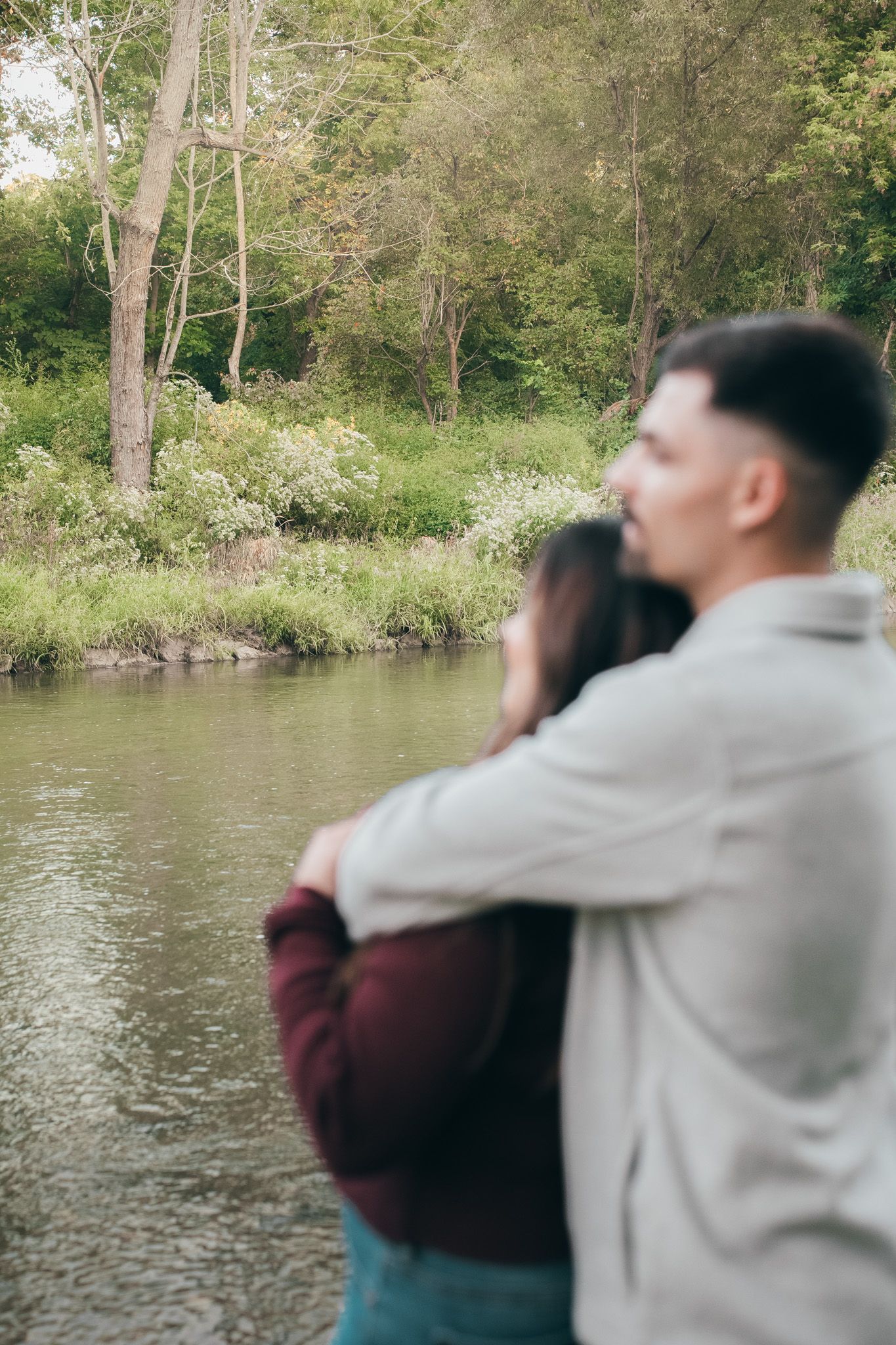 Series of shots showing a couple by a serene lake in natural lighting.