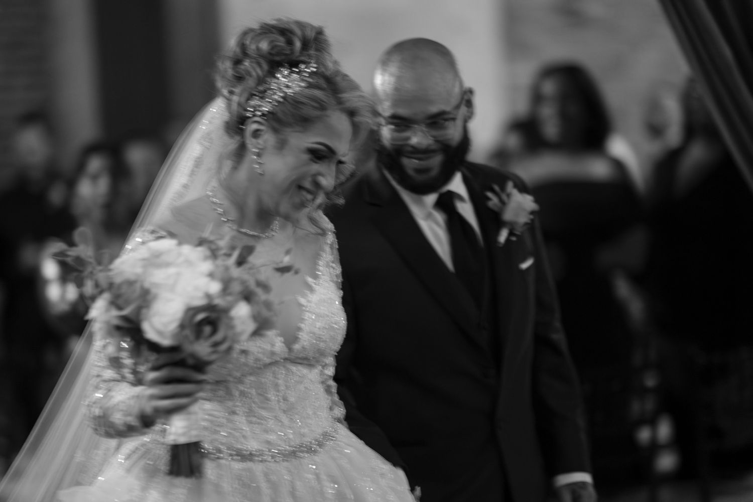A series of black and white wedding photos showing emotional moments during a ceremony and celebration.