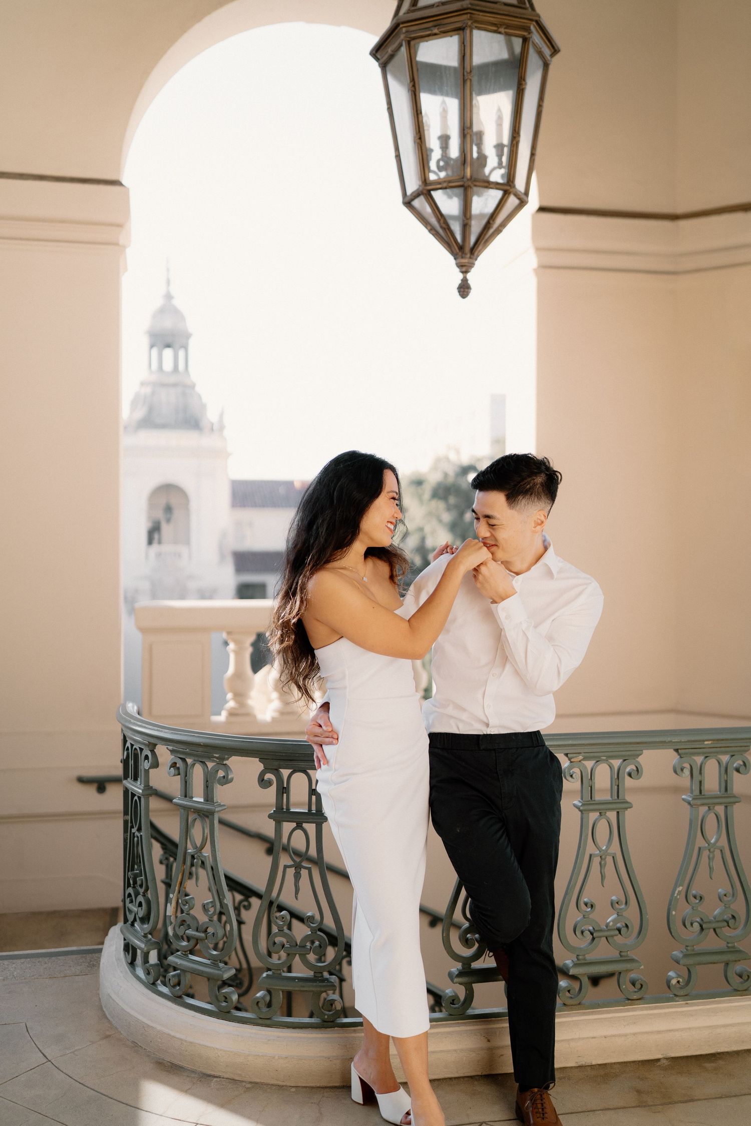 Engagement shoot at Pasadena City Hall. Man kissing woman's hand.