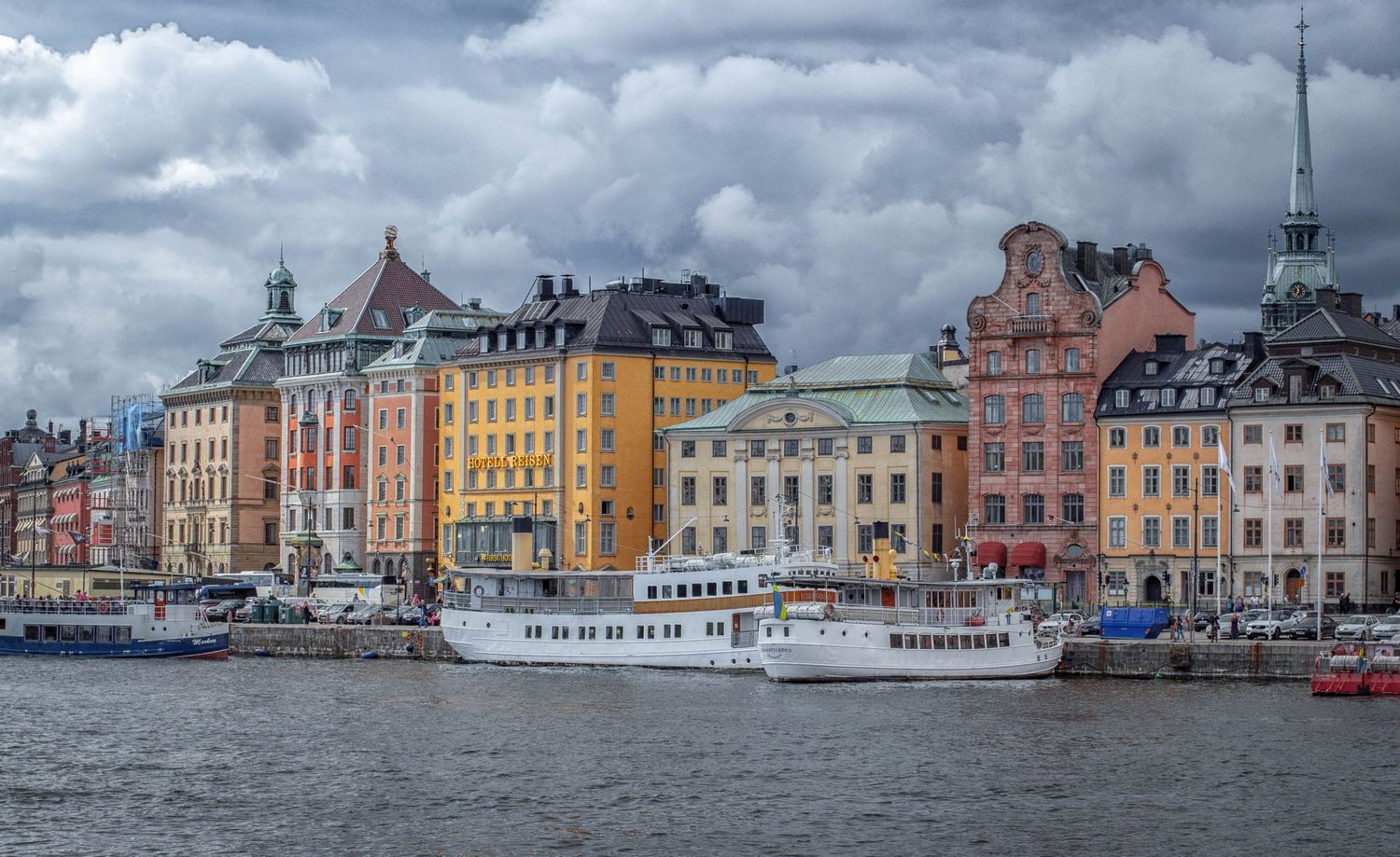 Colorful historic waterfront buildings line the harbor in Stockholm's Gamla Stan district.