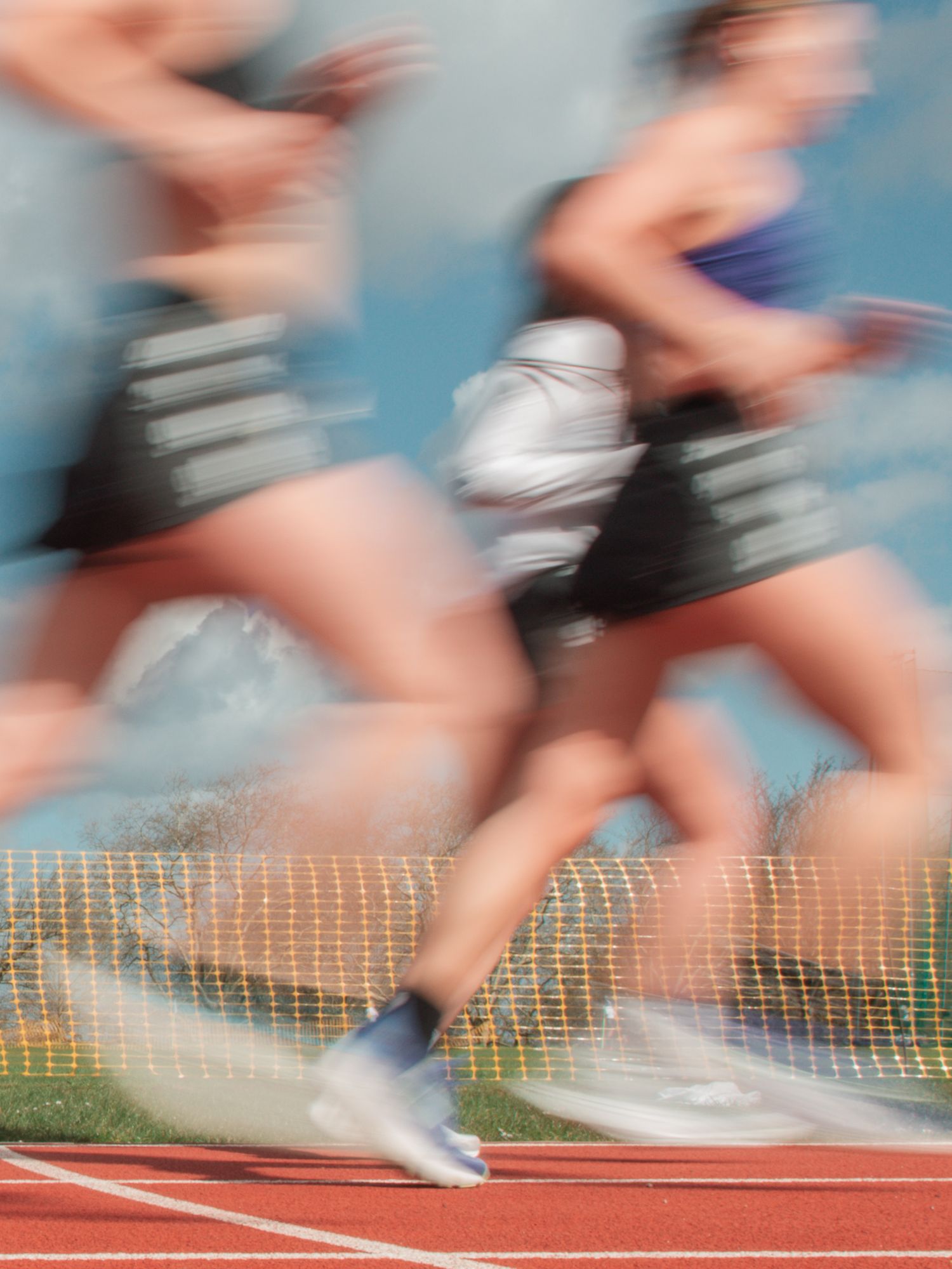 Blurred motion photo of runners racing on track during a Nike time trial in Finsbury Park with Club 99.
