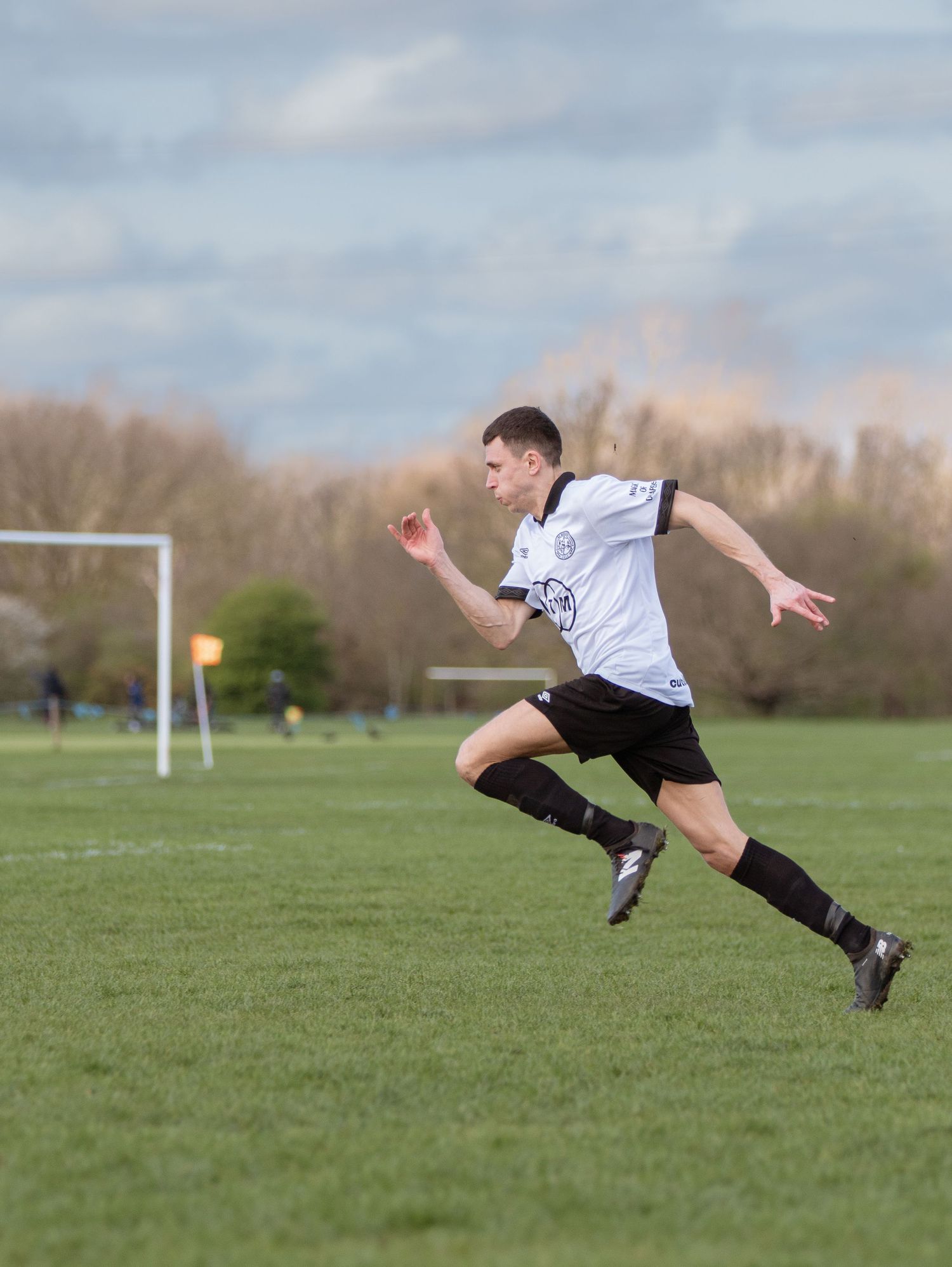 A sequence of photos showing a soccer player diving horizontally through the air to make a dramatic save on the field.