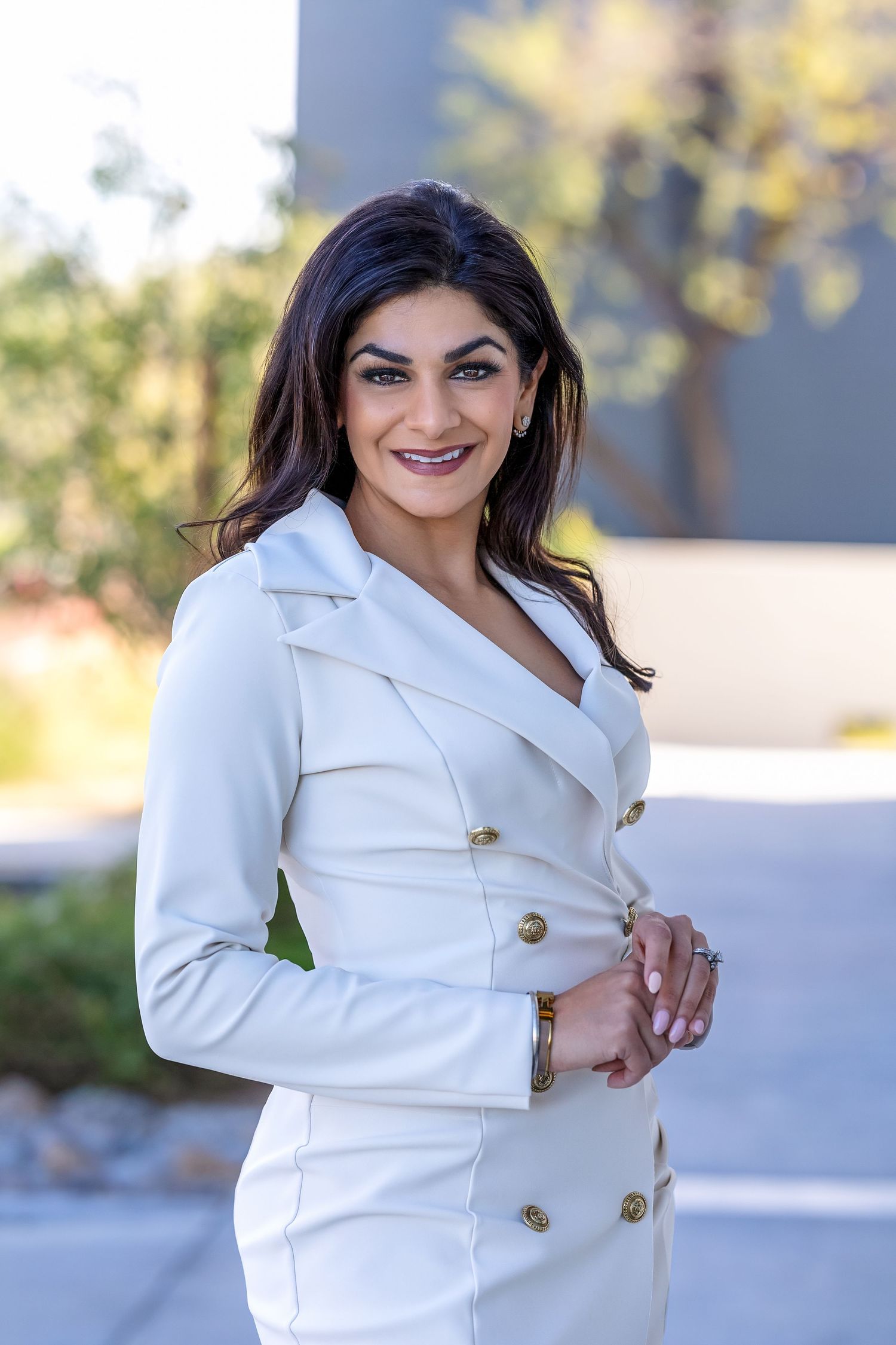Female CEO, white pant suit, in an outdoor setting