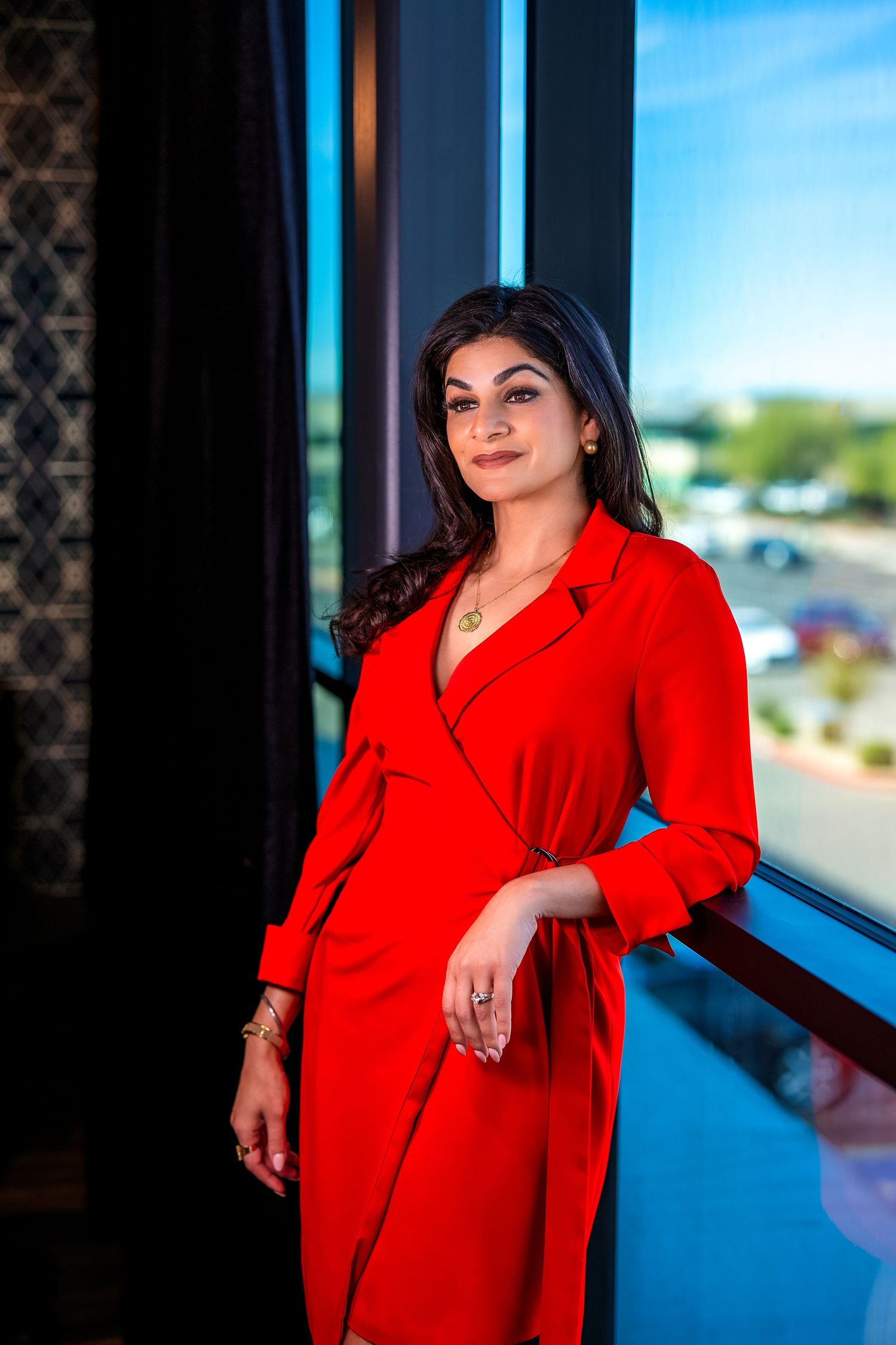 Executive in red power dress casual pose around the office