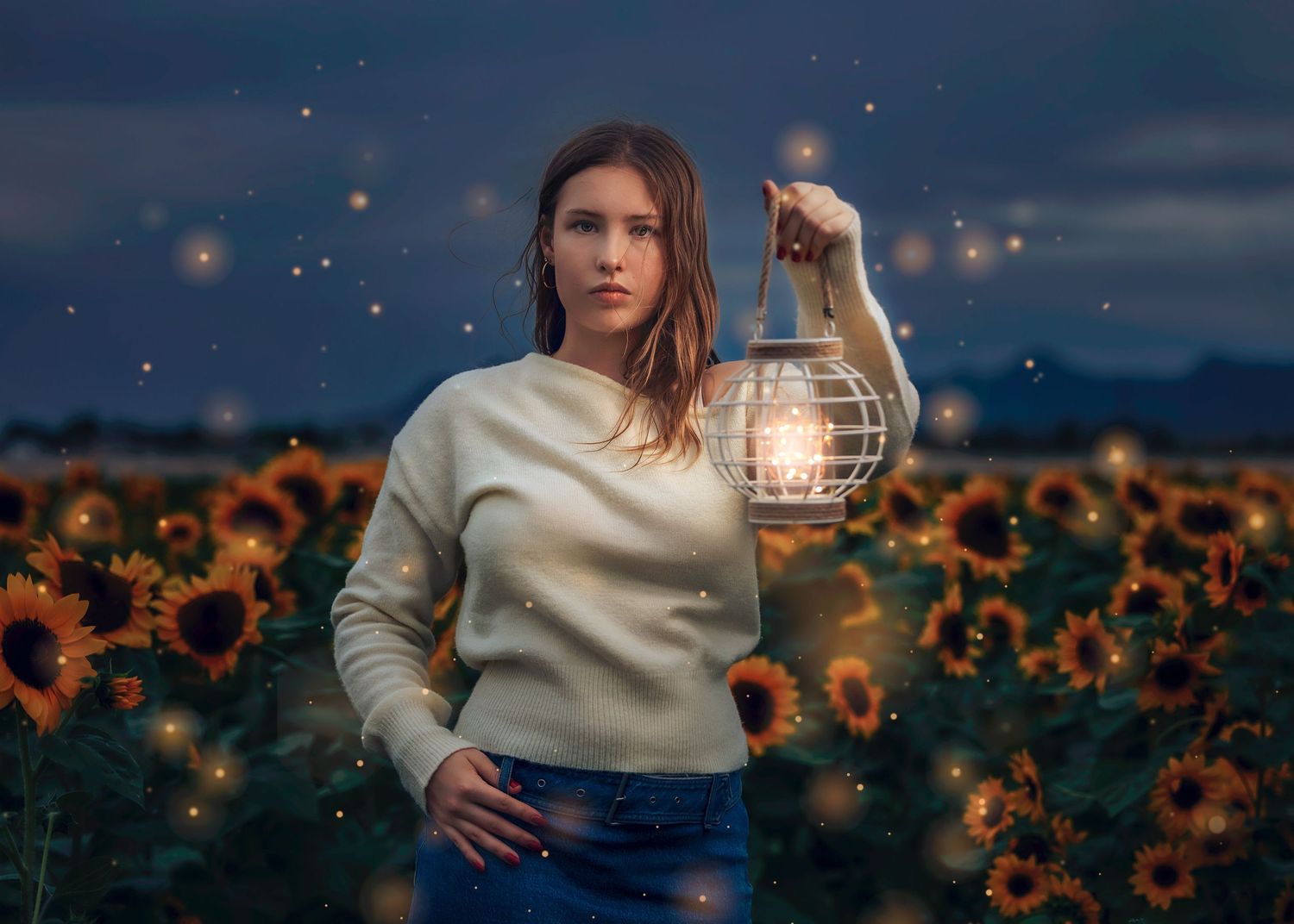 Young woman in beige sweater holding lantern in sunflower field at twilight with fireflies.