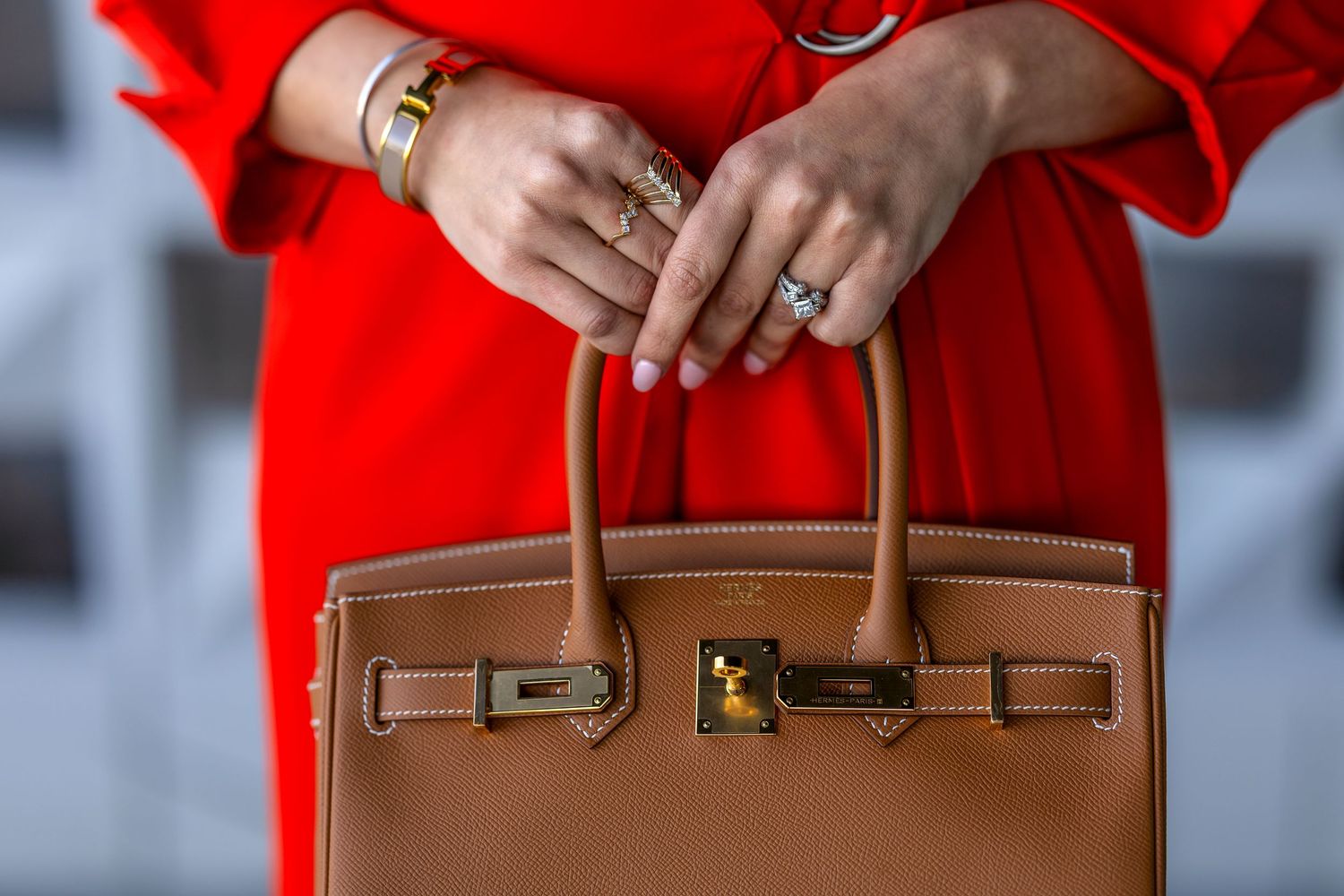 Woman in red dress with Hermes Birkin Bag