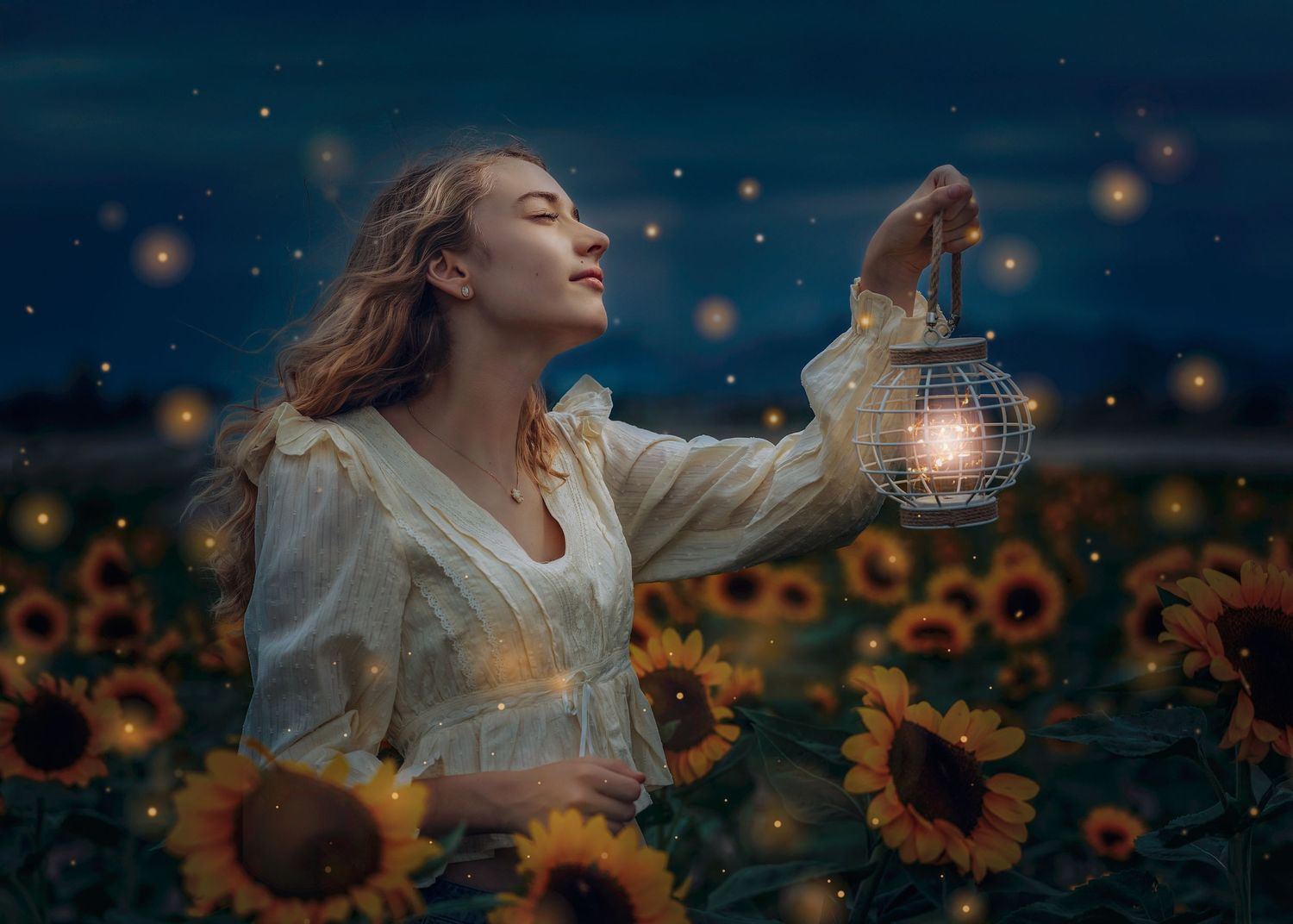 Serene woman in white dress raising a glowing lantern in a sunflower field at twilight.