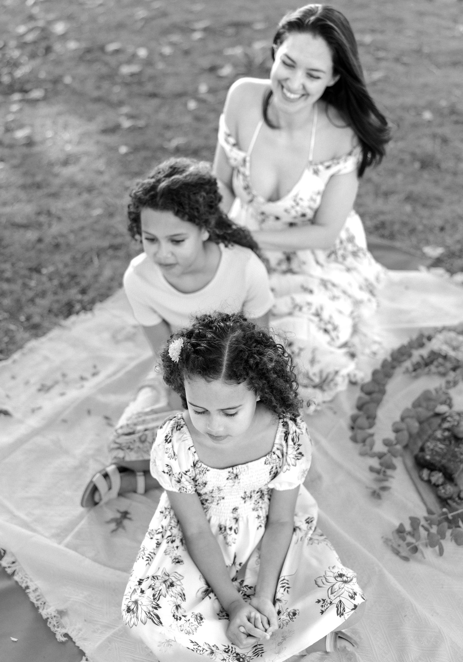 mother and two daughters sit in a row