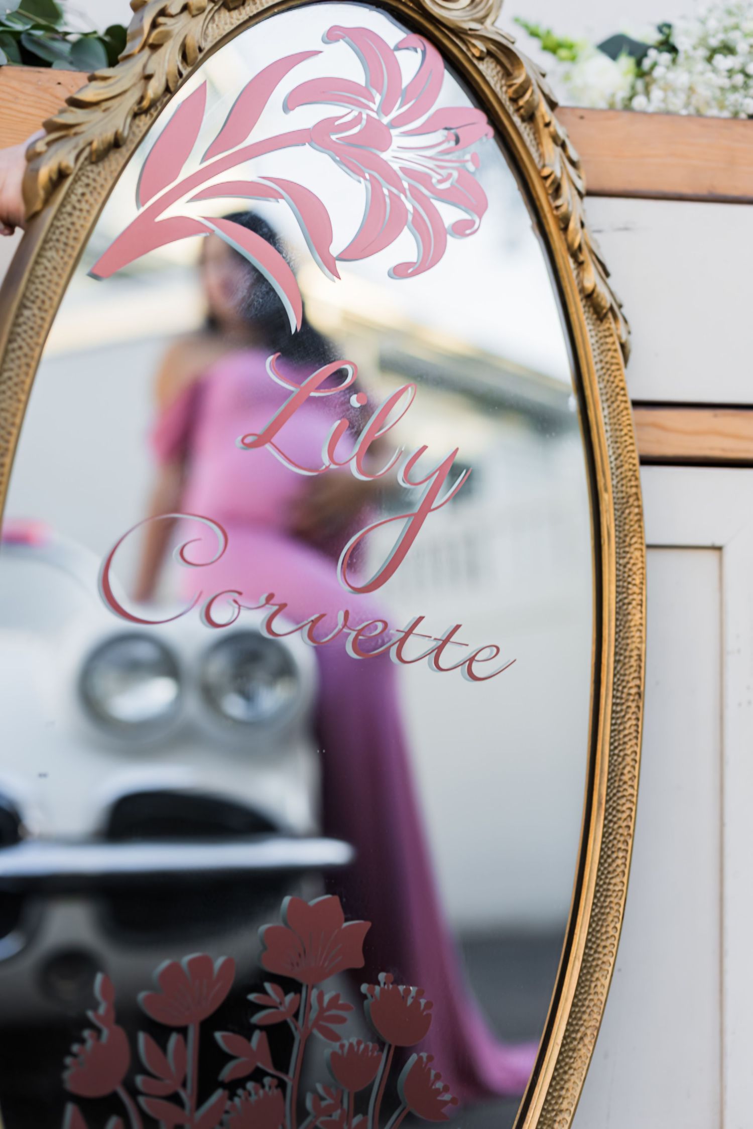 female in mirror along with a classic car