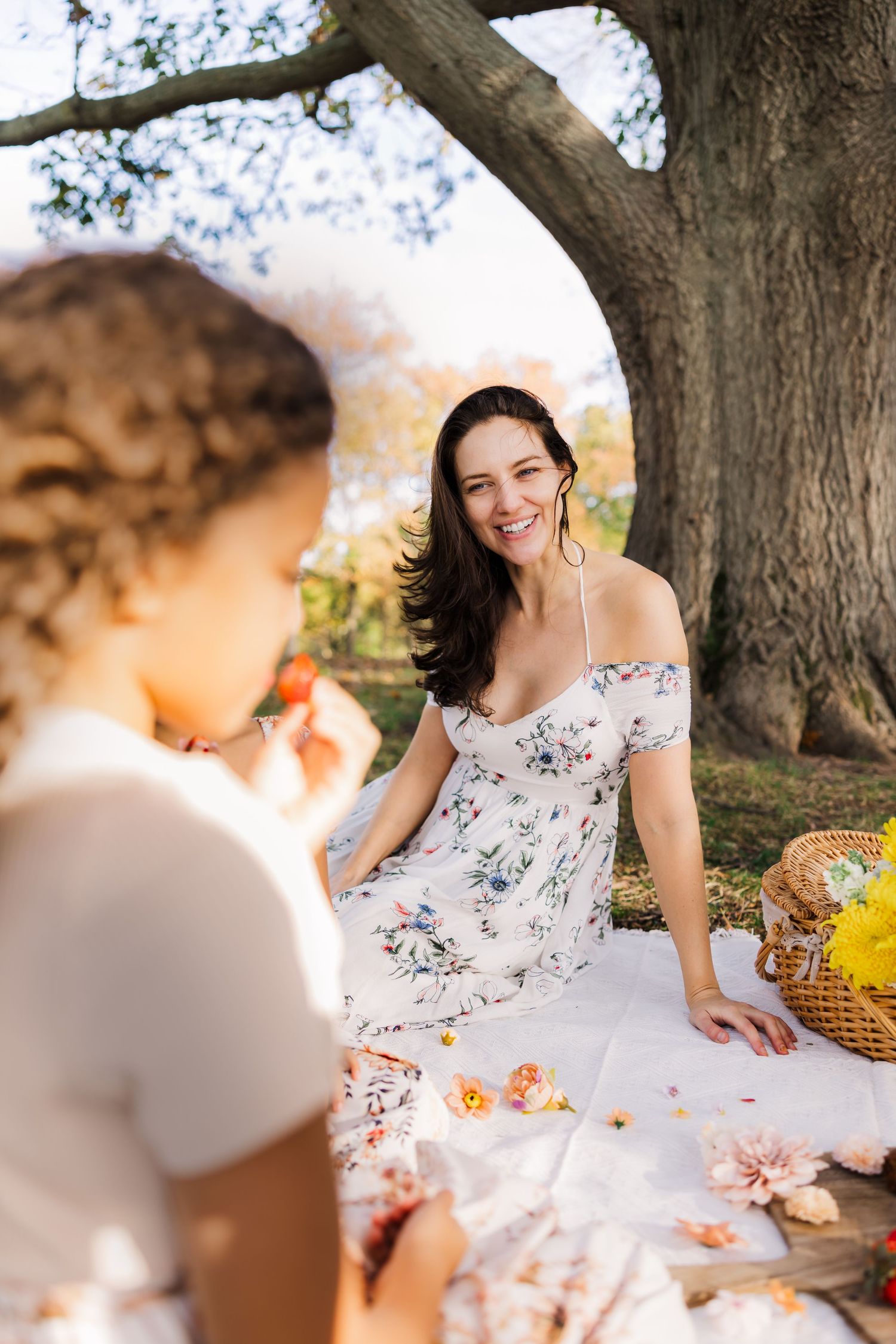 mother watches daughter on picnic setting