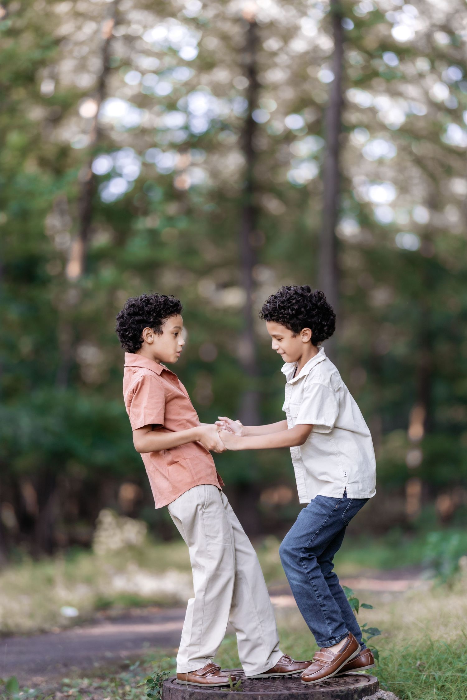 two boys playing in a forest