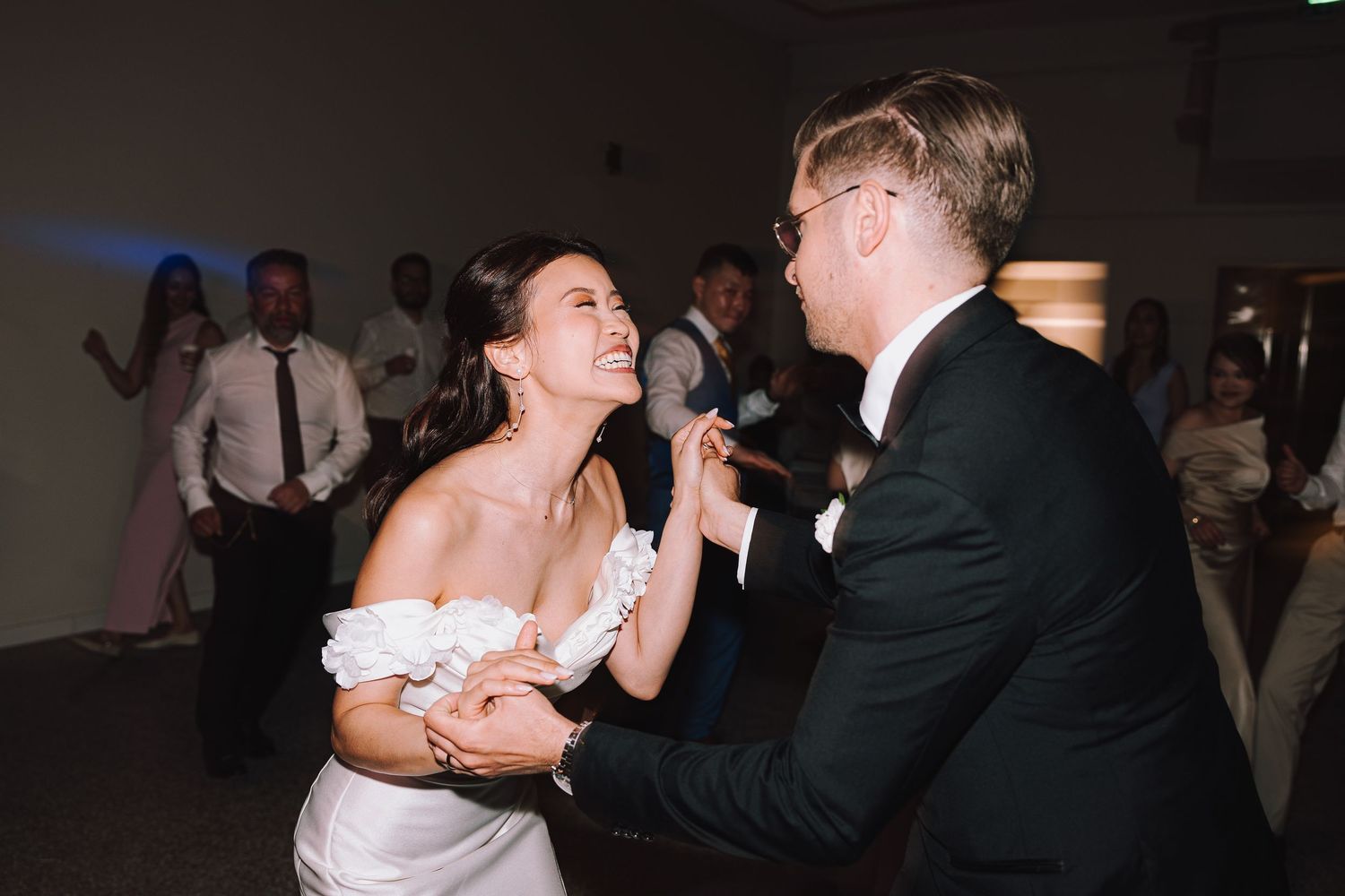 Wedding reception dance sequence captured in dim romantic lighting.