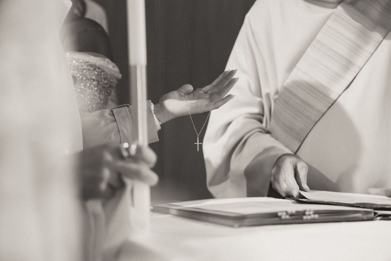 Vintage black and white photos show hands writing and working with paper documents at a desk.