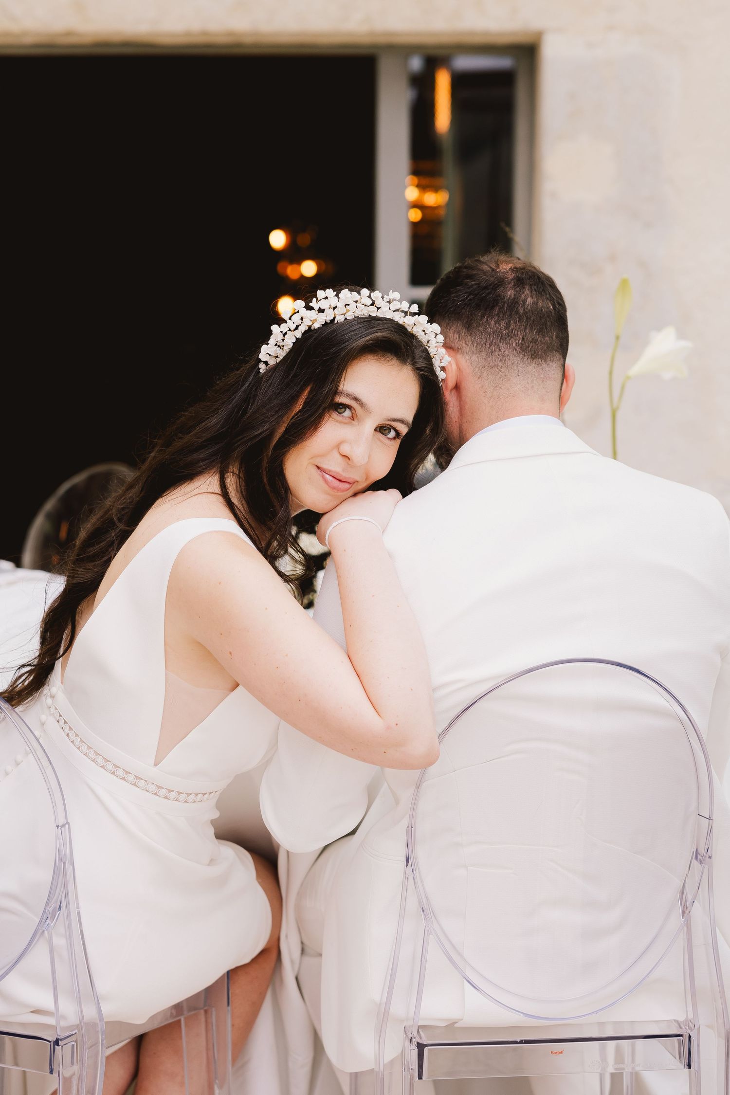 Romantic moment captured in soft white tones at an elegant wedding reception.