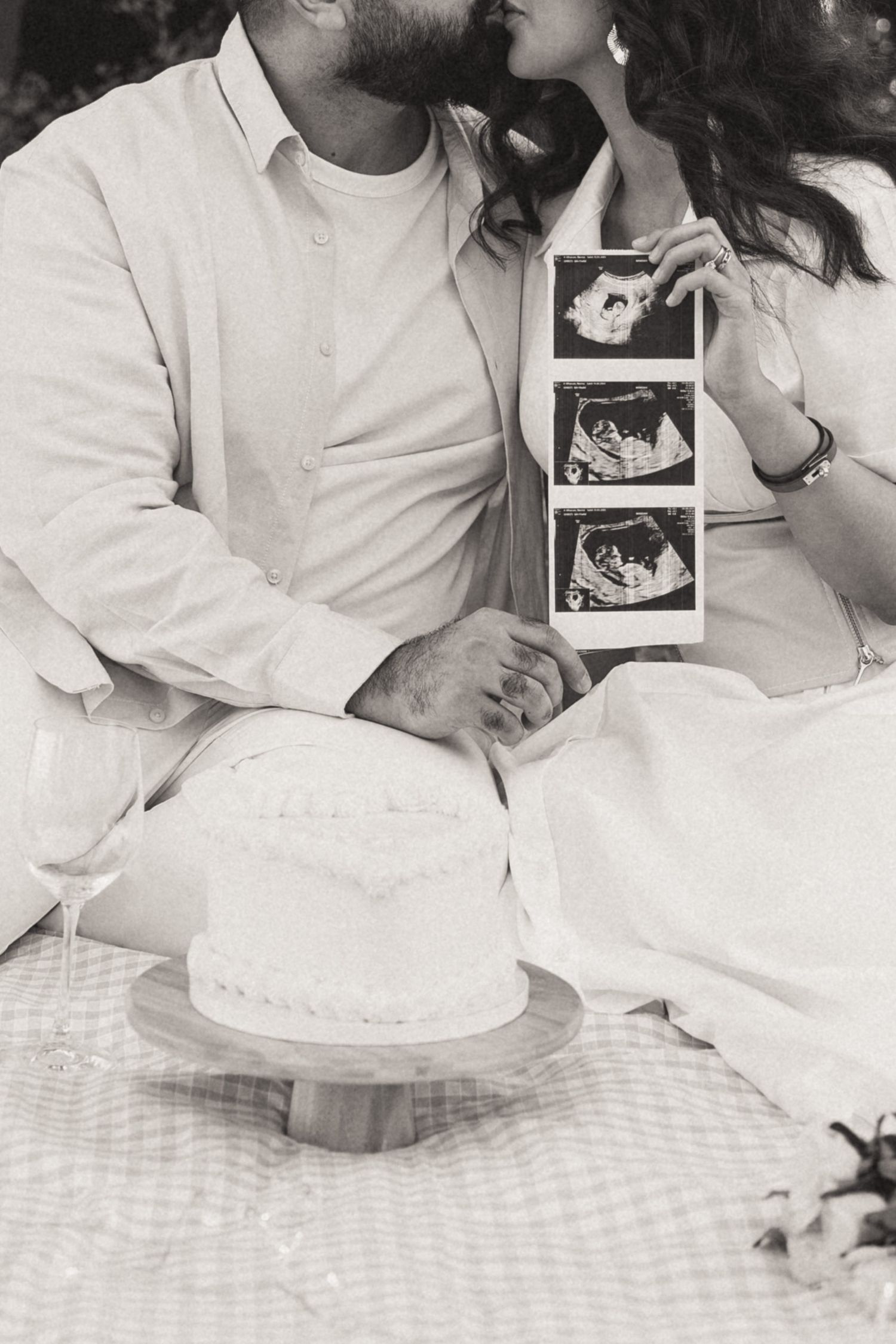 Black and white candid moments captured on checkered tablecloth with decorative plates.