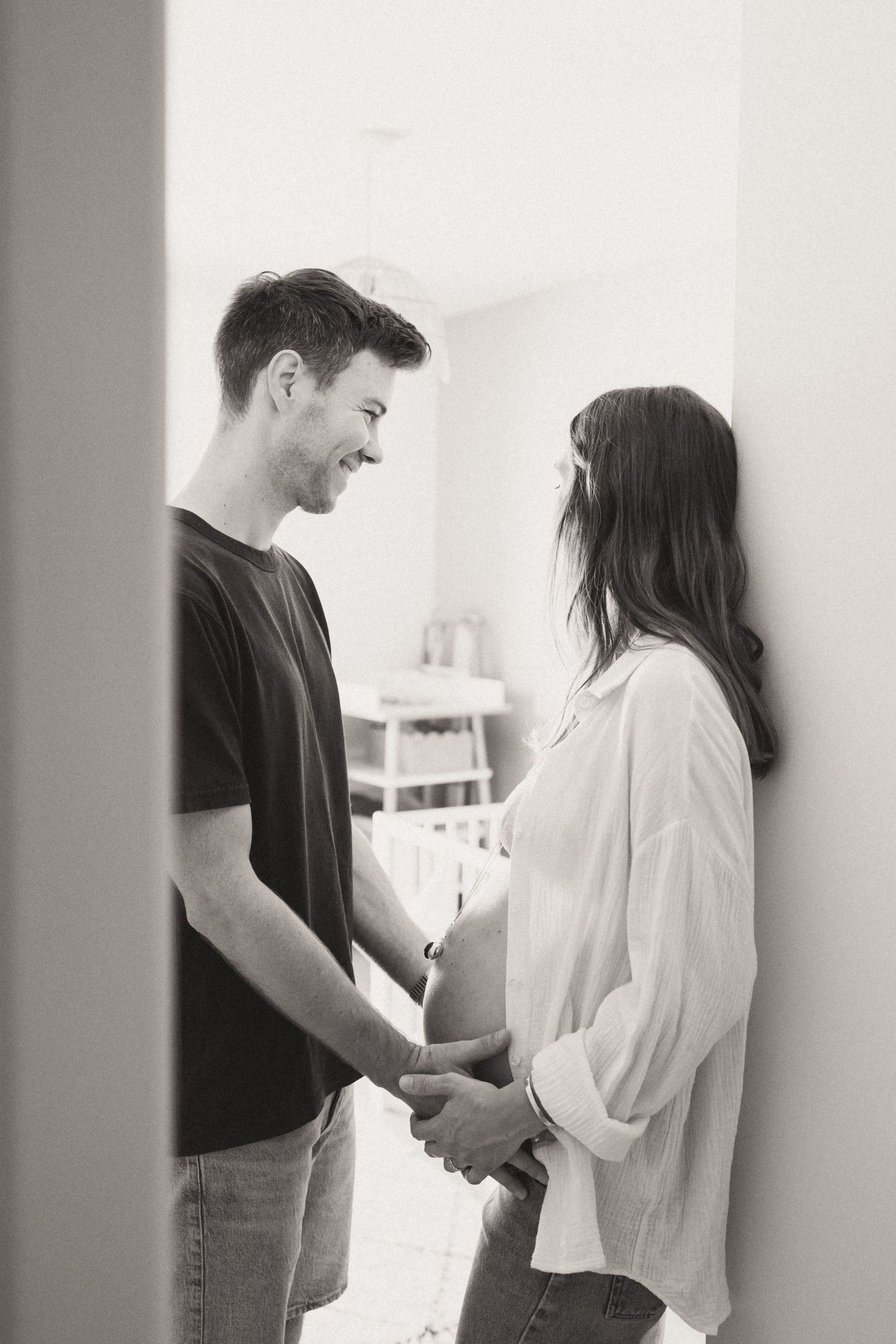 A black and white photo series showing an intimate moment between two people in casual attire standing together.