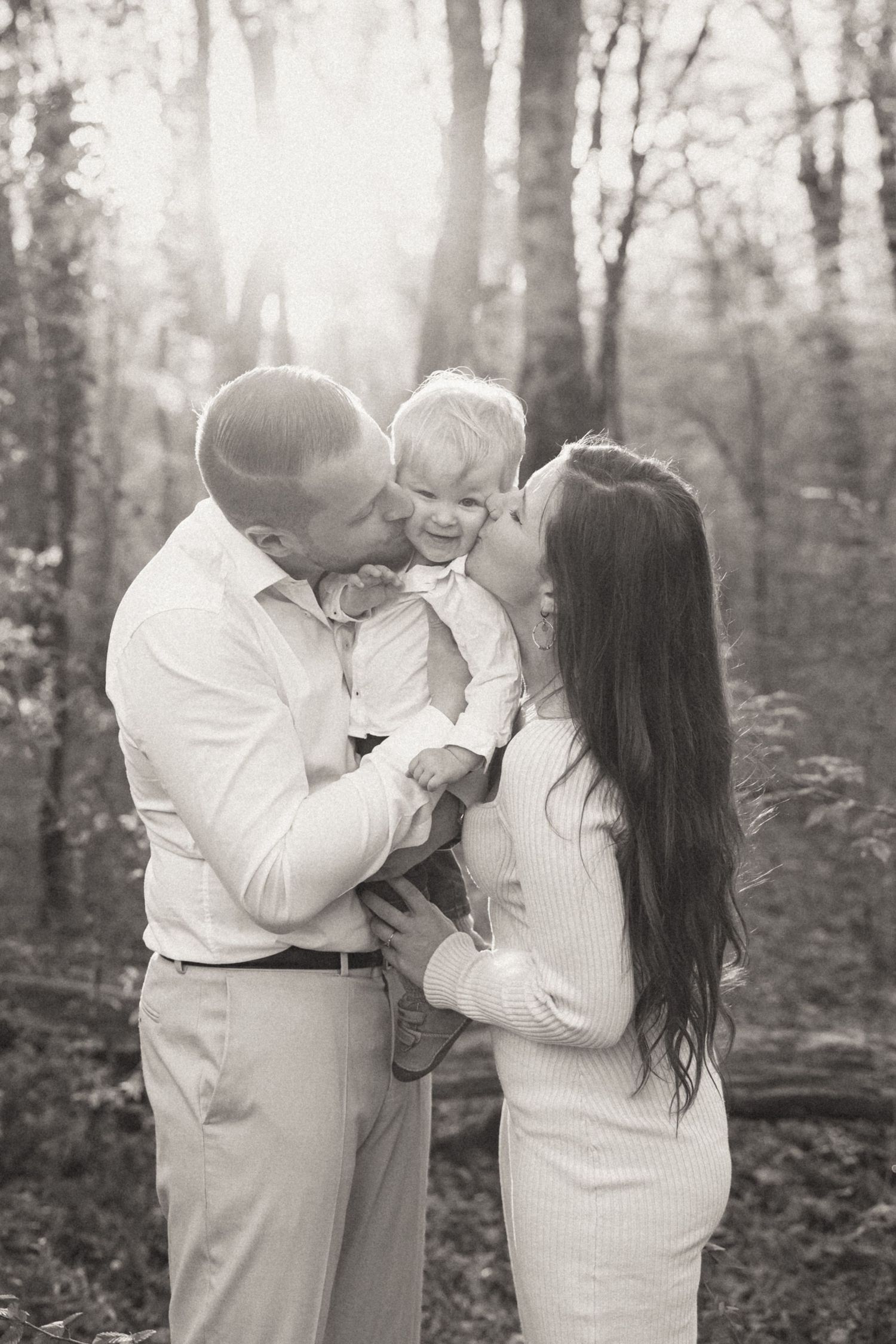 Black and white series of romantic couple photos capturing tender moments together in a serene forest setting.