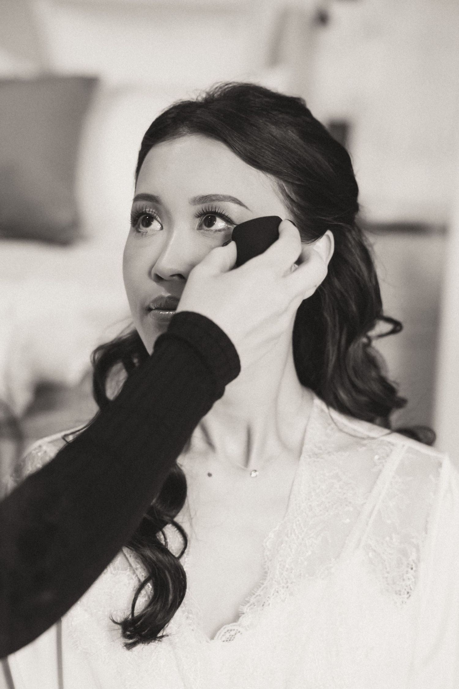Black and white wedding portrait sequence showing emotional makeup application.