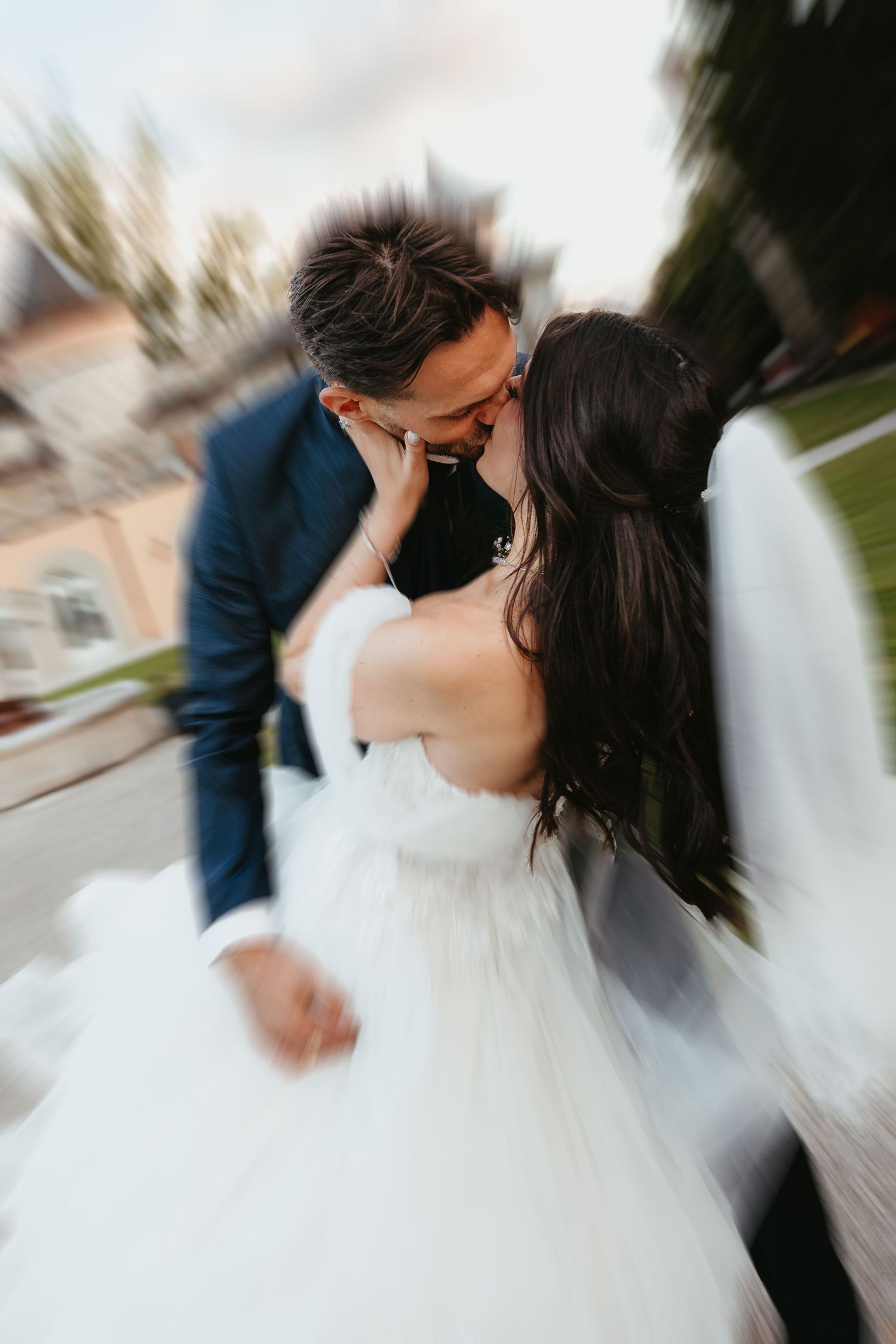 Romantic wedding sequence showing multiple angles of a couple sharing a kiss in motion.