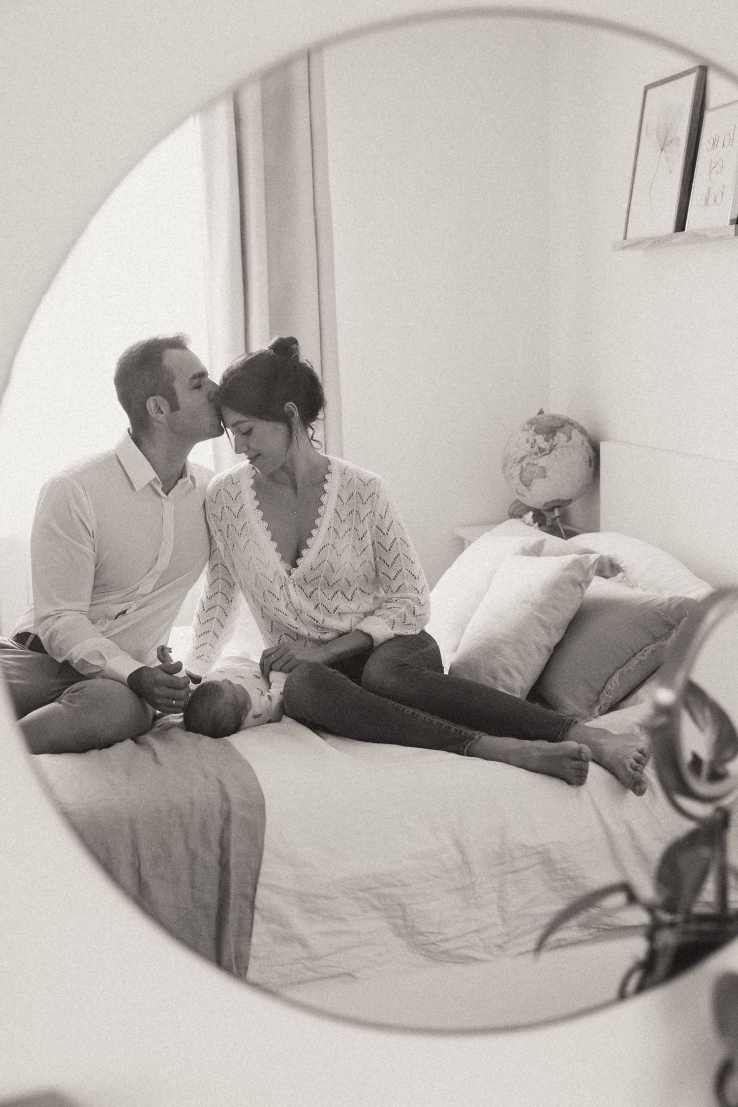 A montage of black and white photos showing a couple lying together intimately on a bed.