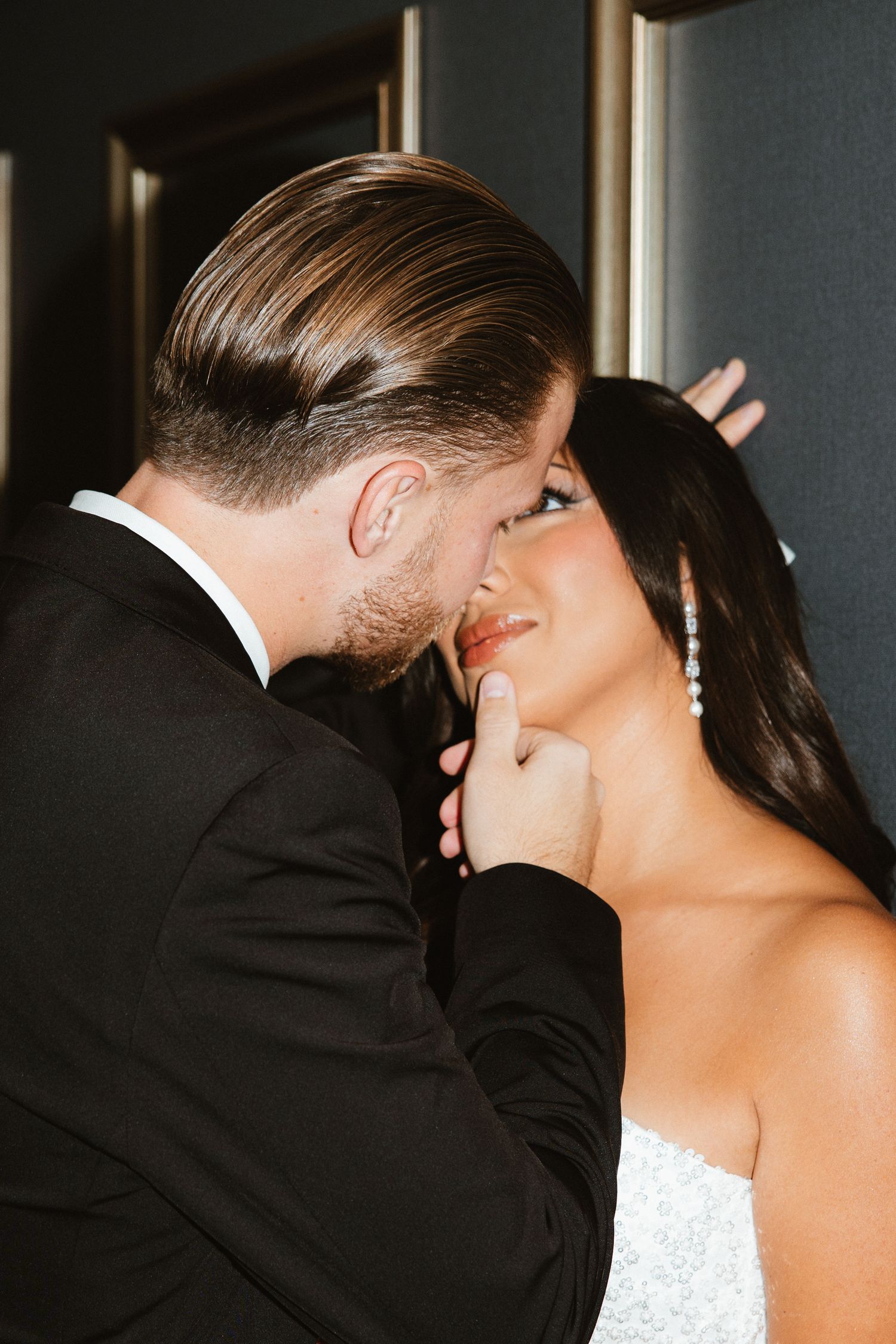 Romantic sequence of a bride and groom sharing an intimate kiss at their wedding ceremony.