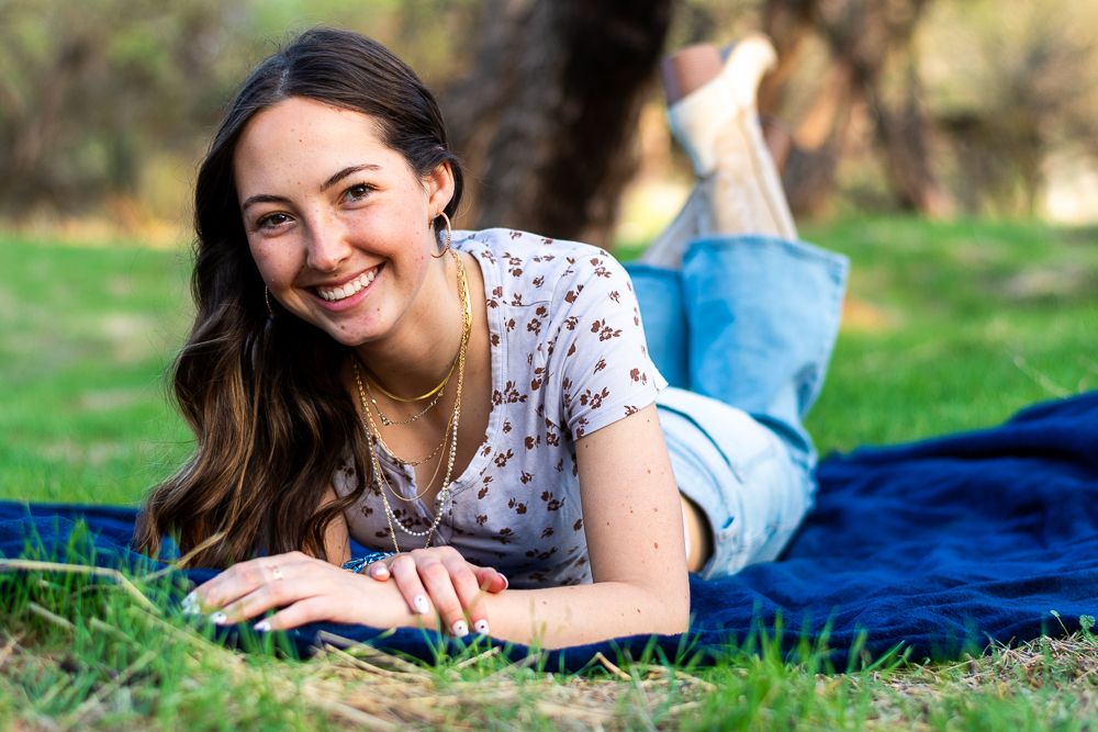 Moon Valley senior portrait session - high school girl relaxing on grass at outdoor Phoenix AZ location