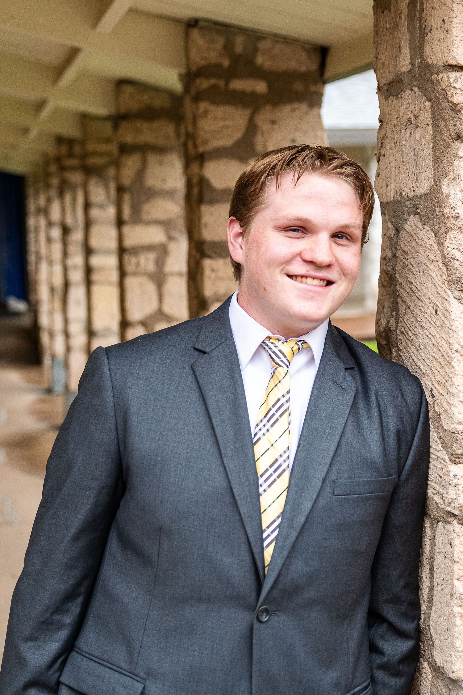 North Phoenix senior portrait session - high school senior boy in suit at architectural outdoor location