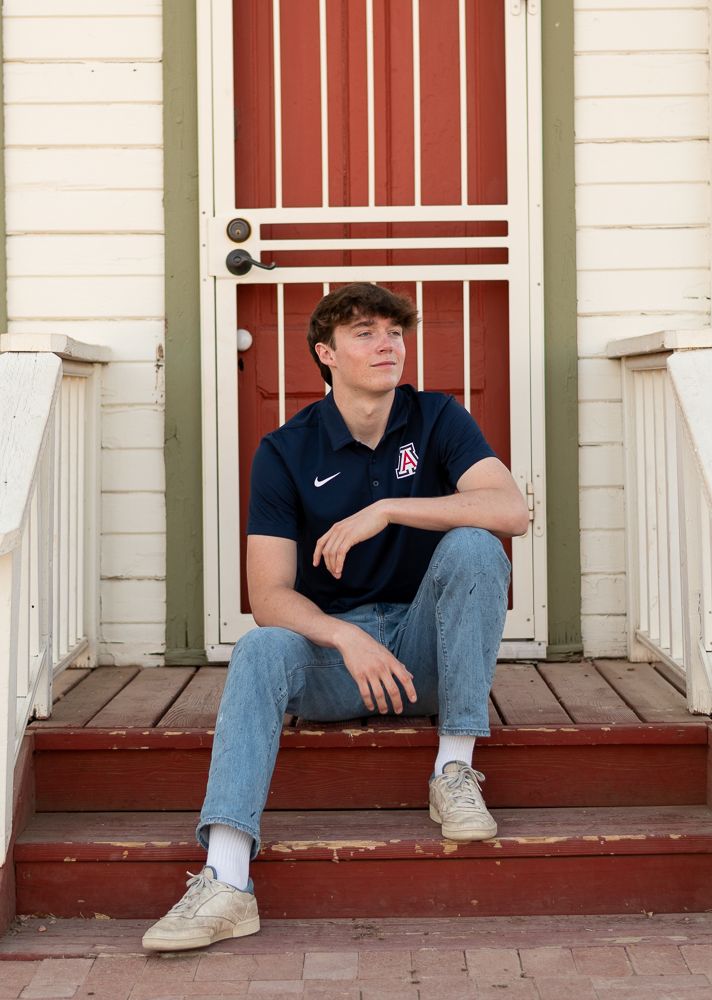 Phoenix AZ senior portrait session - high school boy and girl sitting on steps at colorful door location