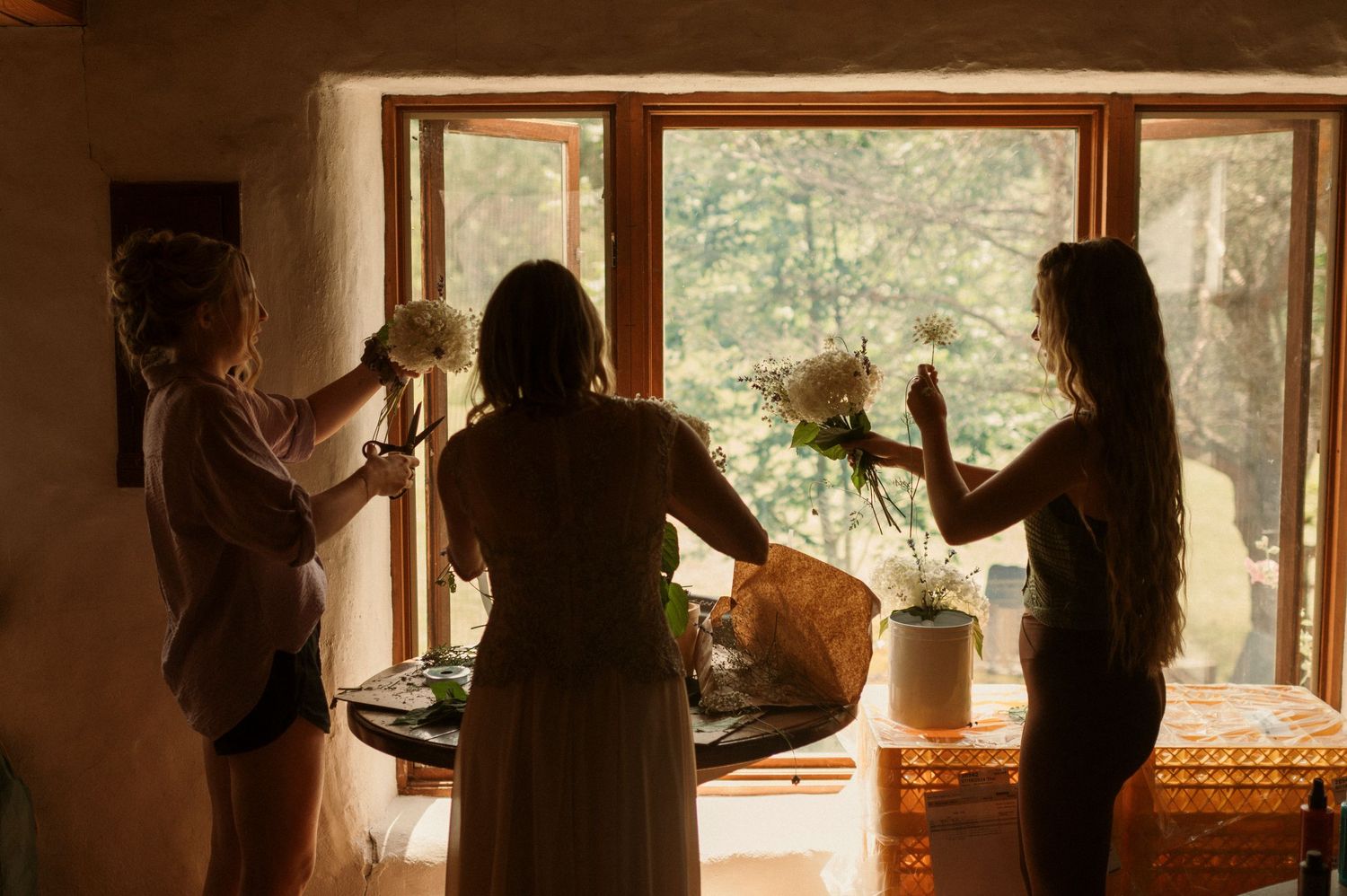 on wedding morning the brides bridesmaids hand made all their bouquets with flowers from their backyard