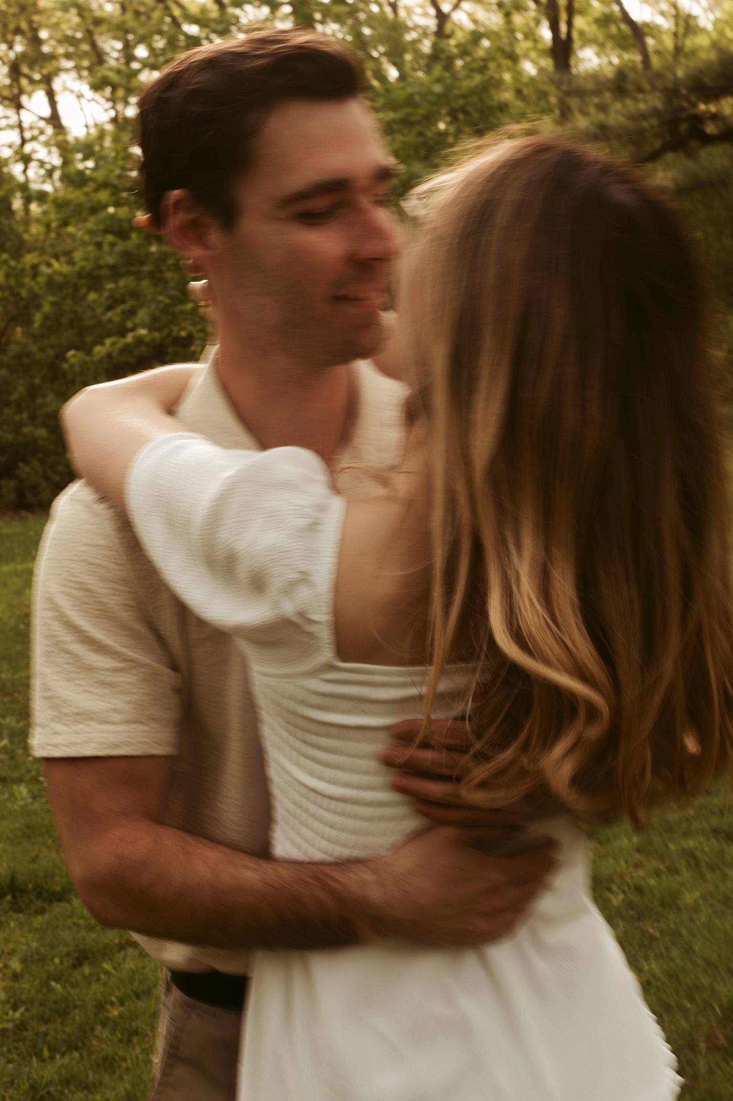couple kissing and dancing around in motion blur