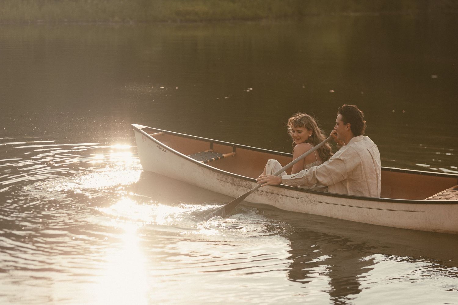 very romantic and artfully crafted image of a couple canoeing on the water