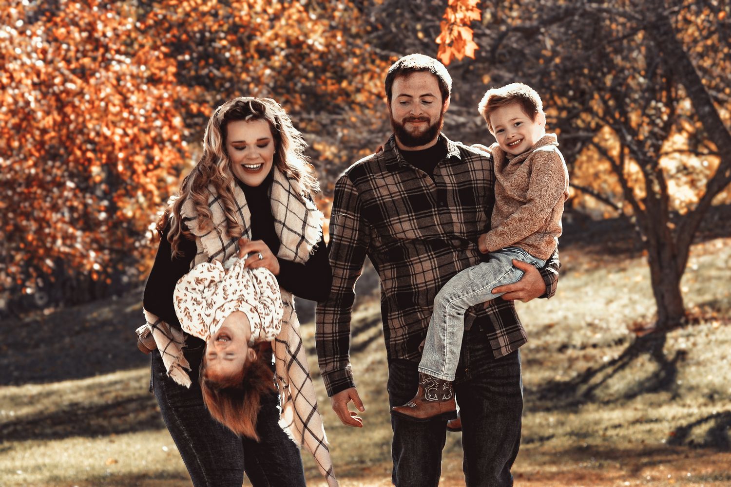 Casual family portraits captured against a backdrop of autumn trees and golden sunlight.