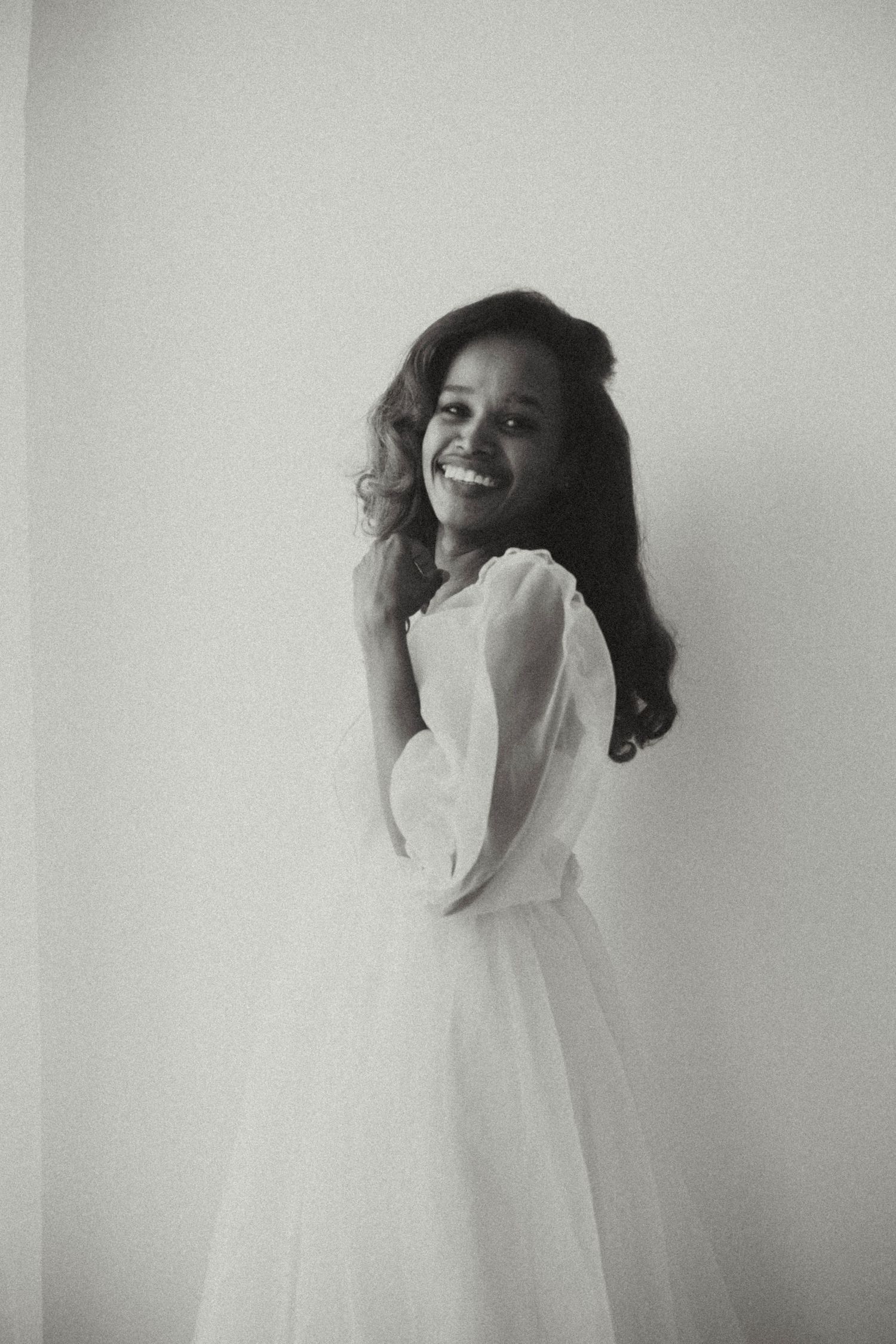 Black and white photo series capturing carefree dancing movements in a minimalist setting.