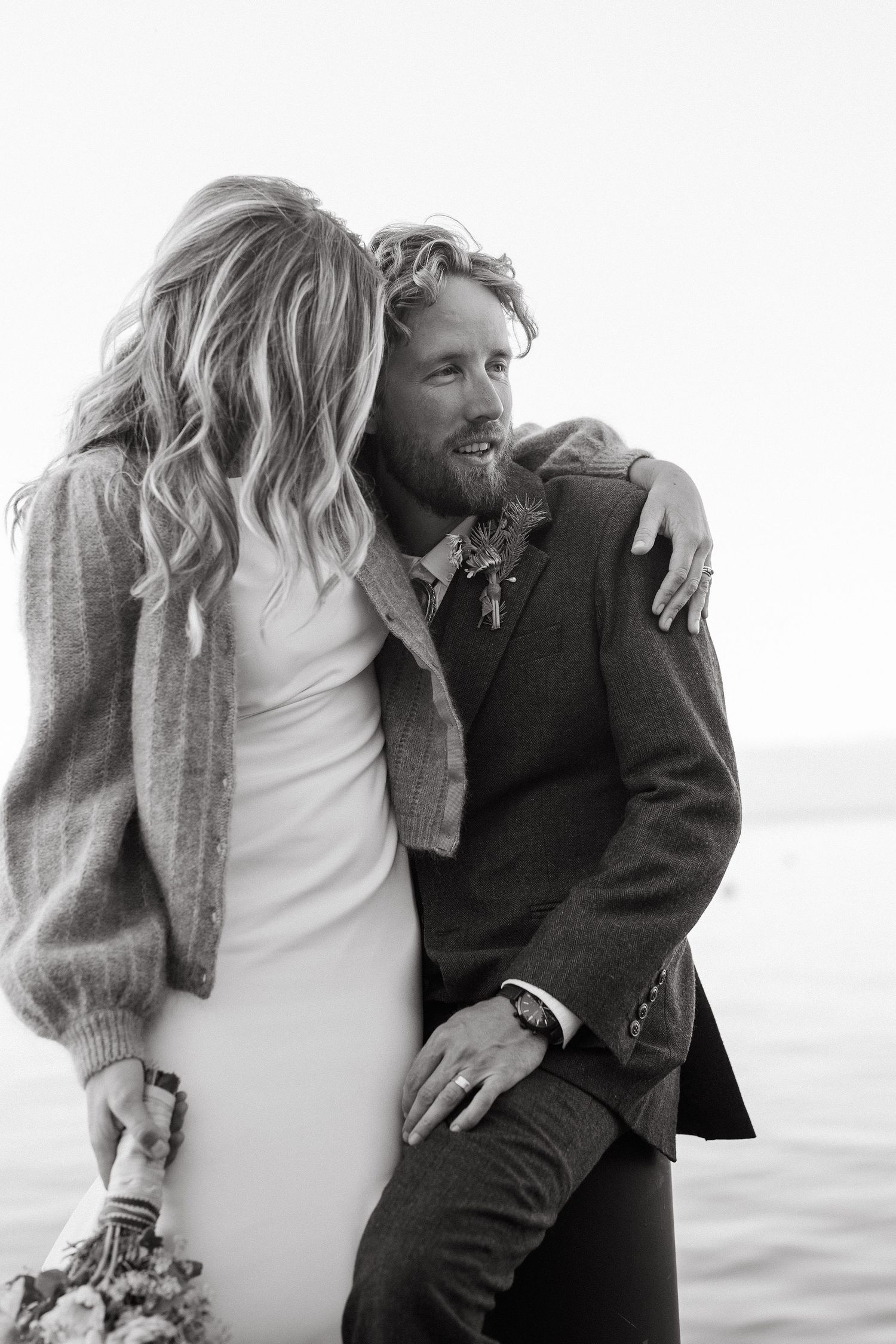 Black and white romantic wedding portrait by the water.