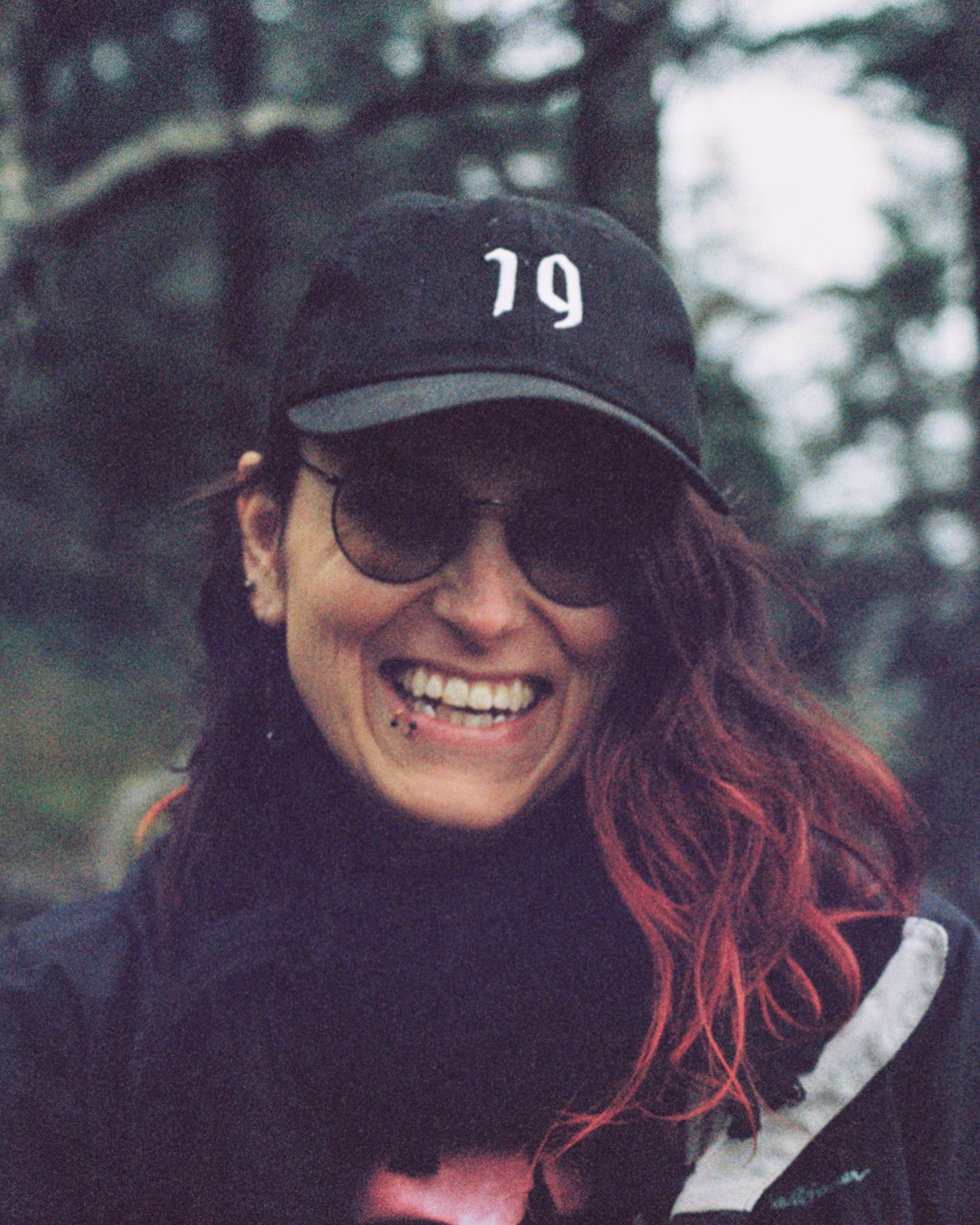 A picture of Selaine smiling, wearing her cap.