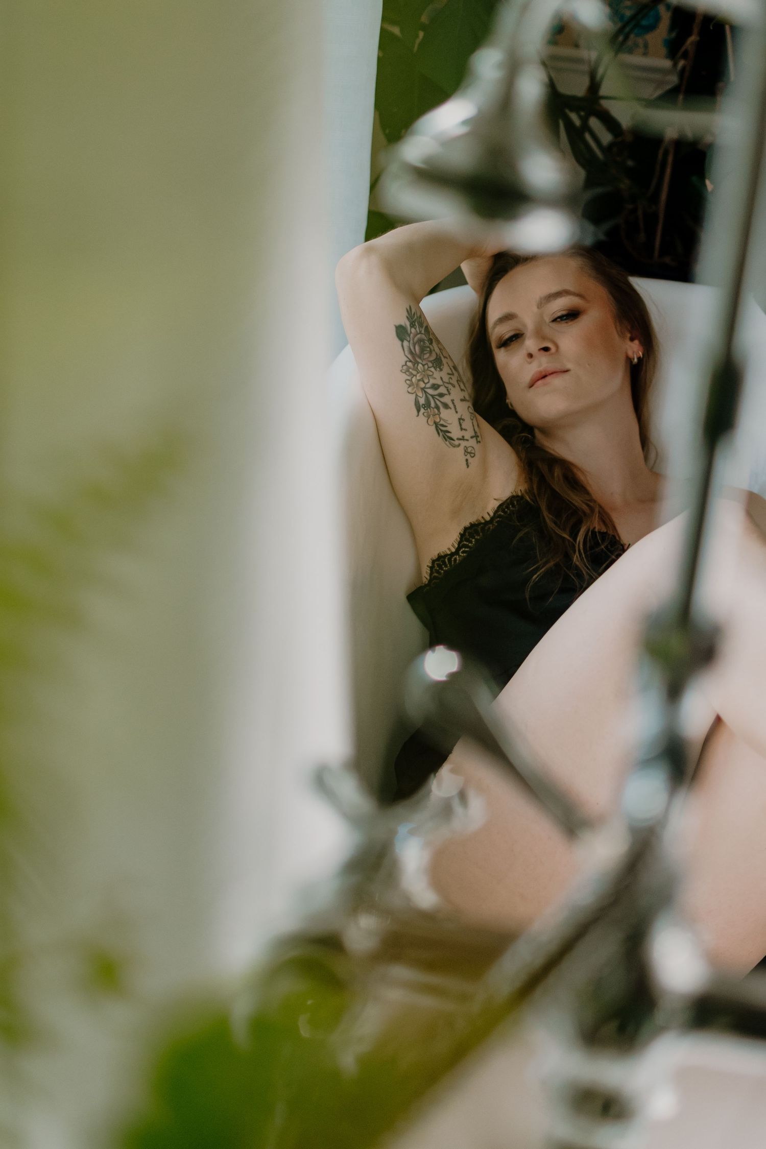 Artistic portrait series showing a figure posing elegantly against a soft, blurred background with natural light.