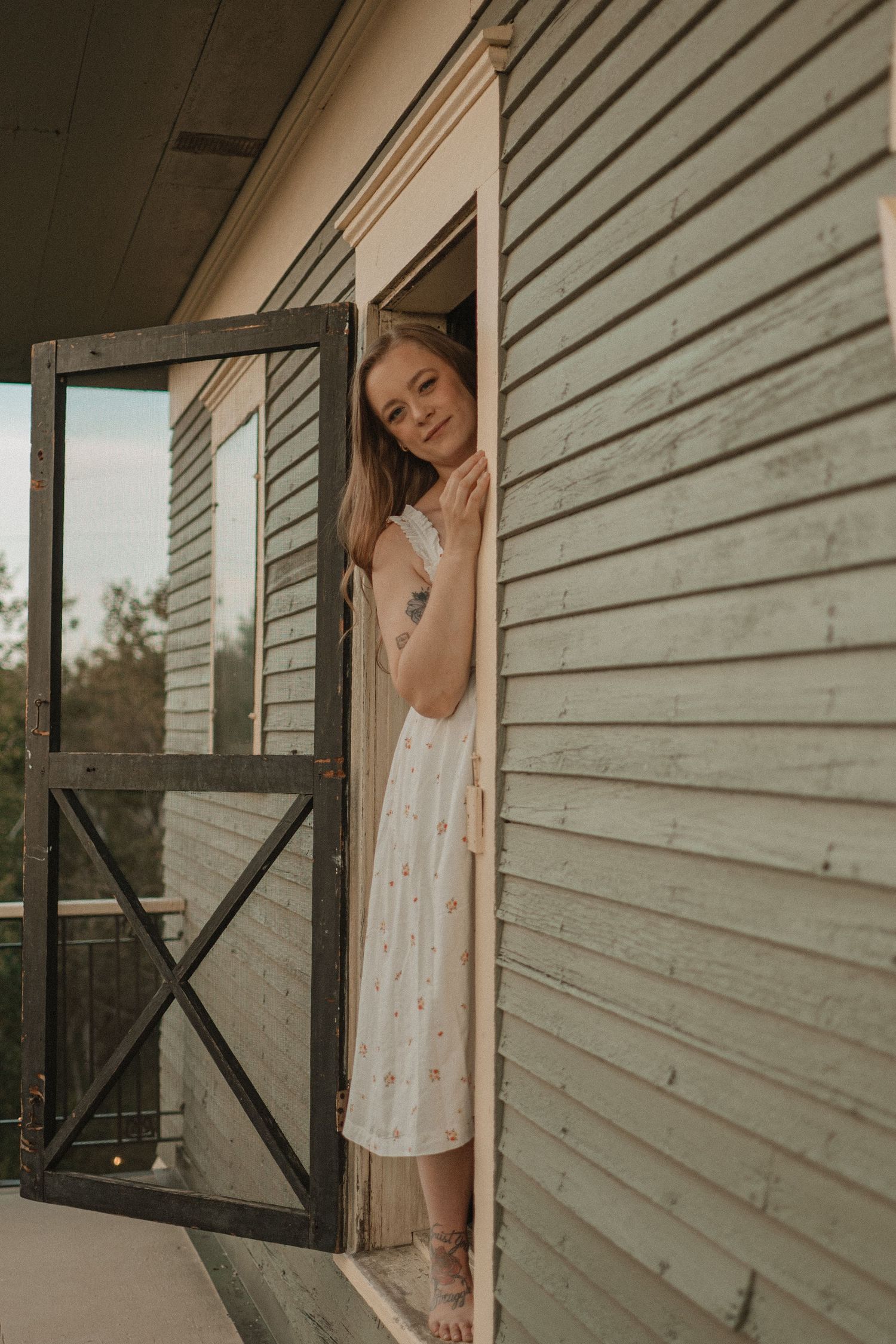 A series of vintage-style photos showing a white lace dress through an open window against weathered siding.
