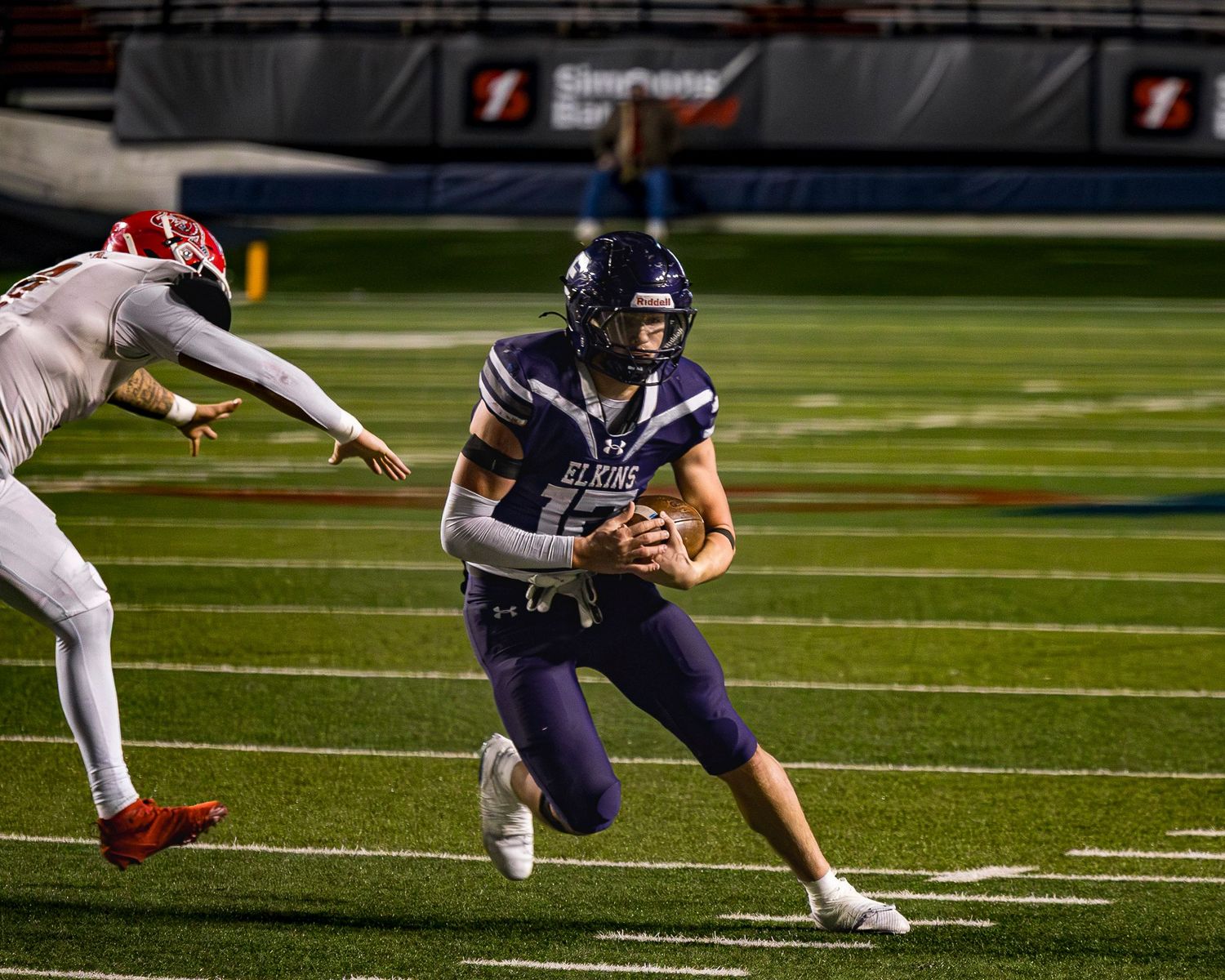 Elkins Elks football player Austin Born runs the ball in the 4A Championship game at War Memorial Stadium in Little Rock
