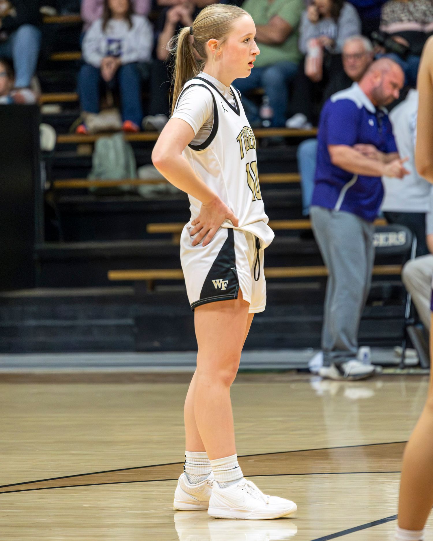Basketball player in white uniform from West Fork stands ready on court to make a free throw. Photo taken by Trevel Young Photography