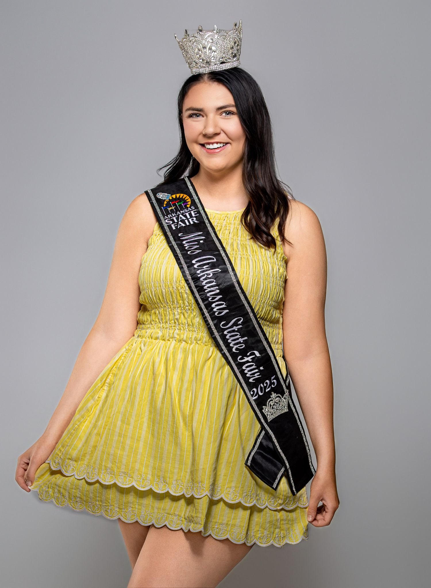 2025 Miss Arkansas State Fair Allison Frazier  yellow dress wearing a pageant sash and crown, posing for a pageant portrait by Trevel Young