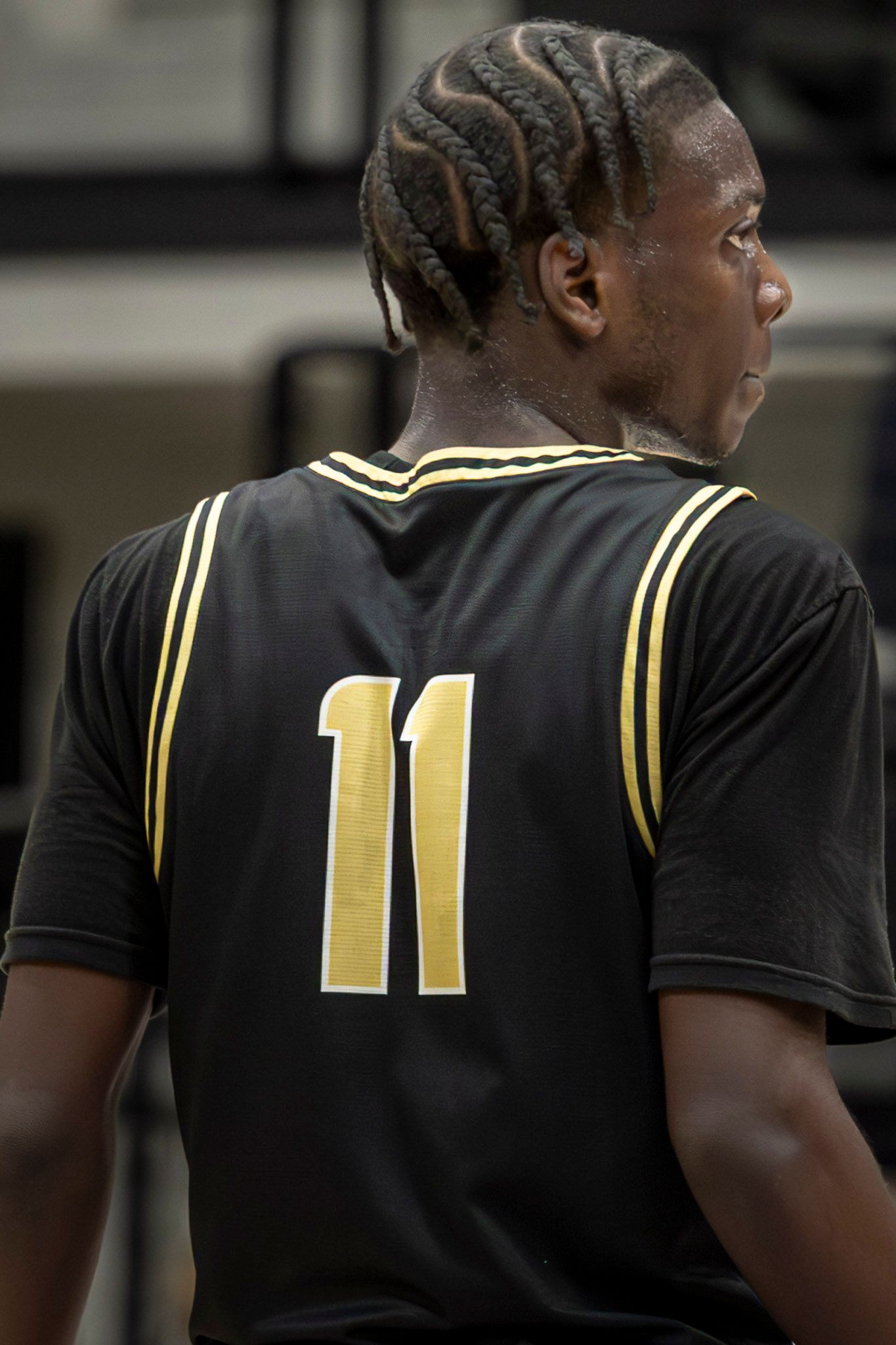 Black and gold sports jersey showing number 11 from multiple angles on a player's back.