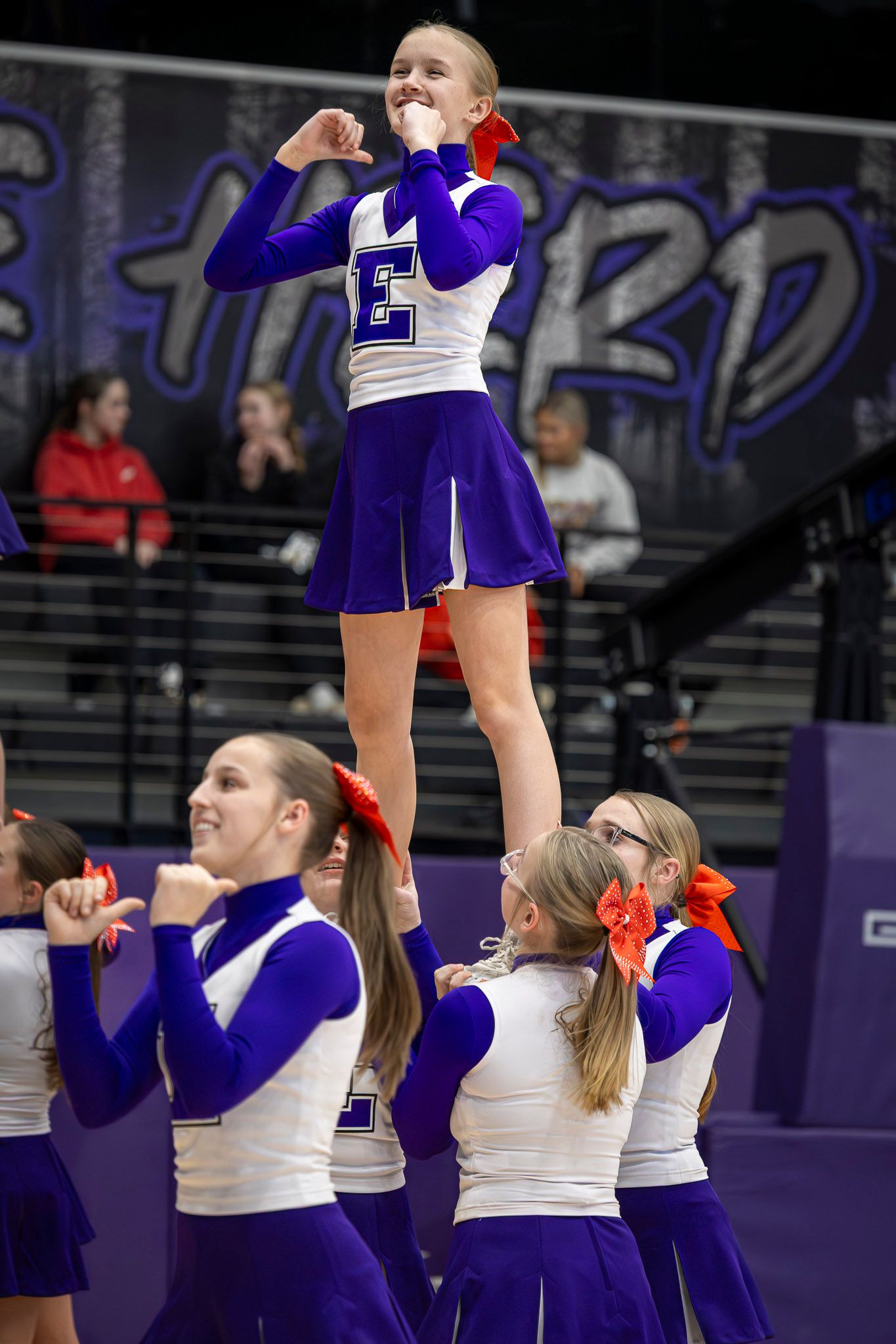 Cheerleaders perform synchronized stunt during a basketball game in Elkins Arkansas. Photo taken by Trevel Young Photography